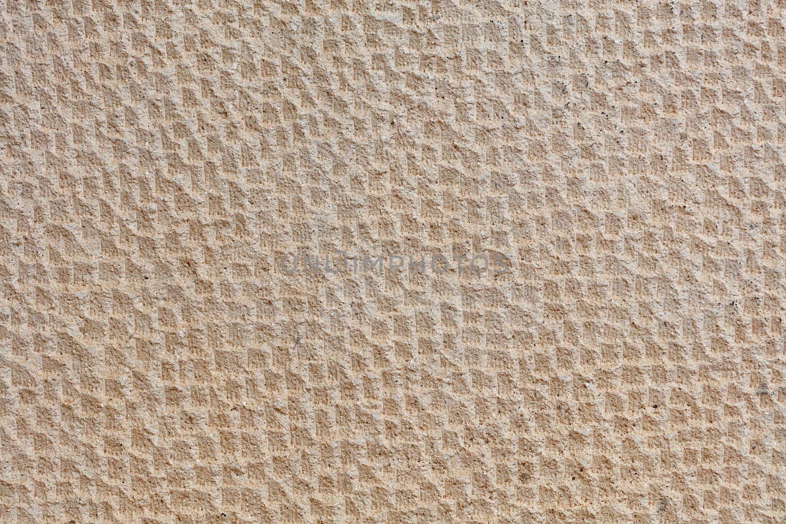 Beautiful uniform beige stone pattern on the wall of shell and stucco.