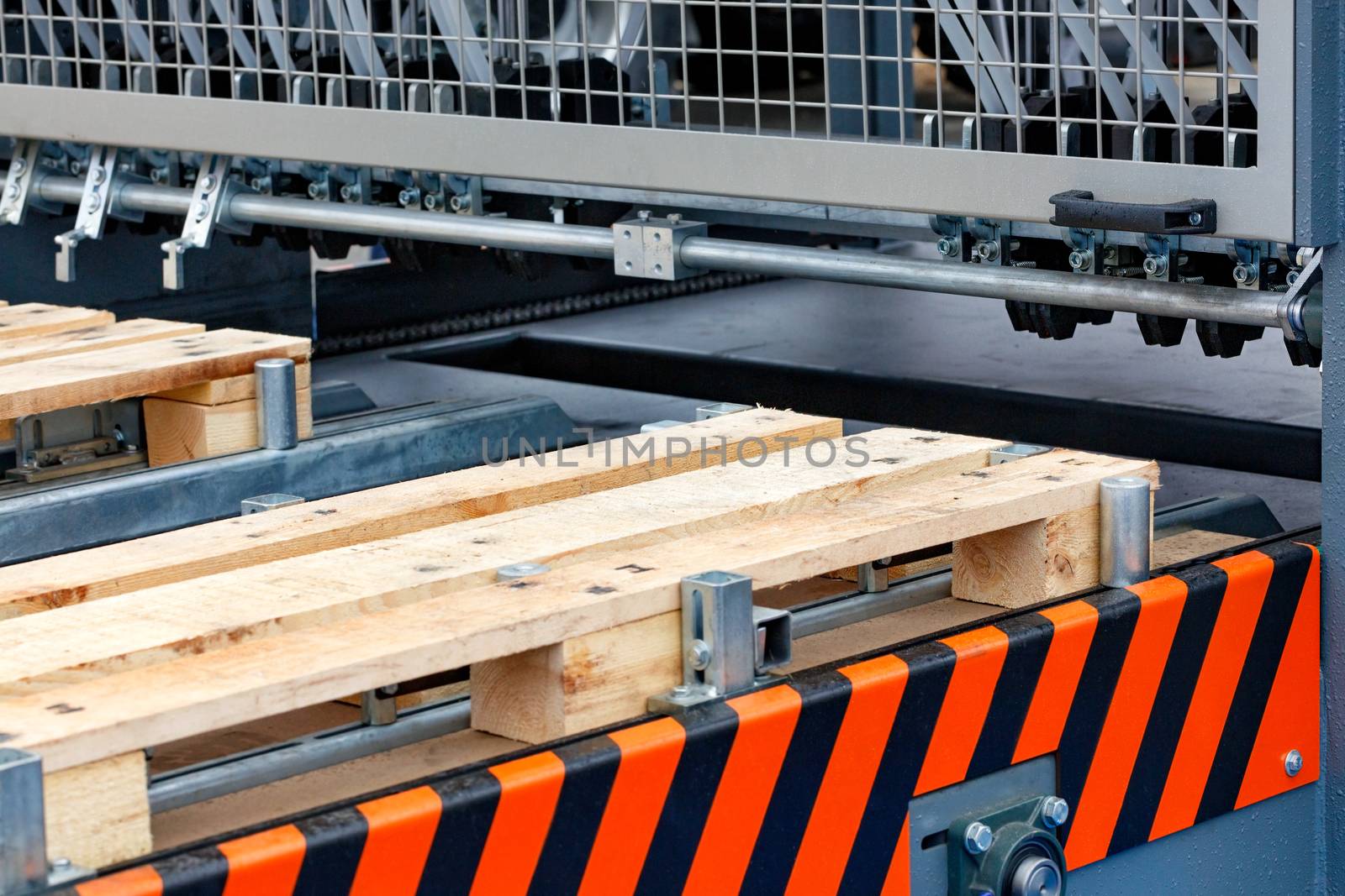 Production of wooden pallets on a modern automatic line, a fragment of the connection of wooden planks.