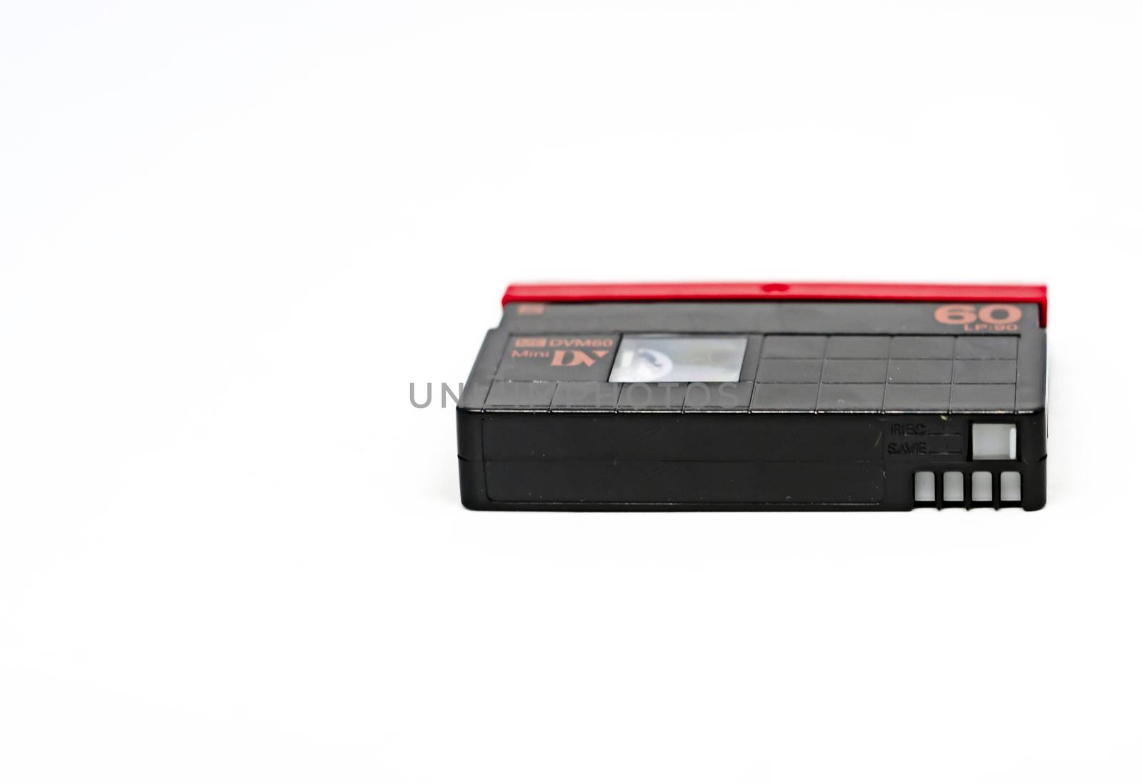 side view of a Mini DV format video cassette isolated on a white background. MiniDV cassettes, had been intended for amateur use, but have become accepted in professional productions as well