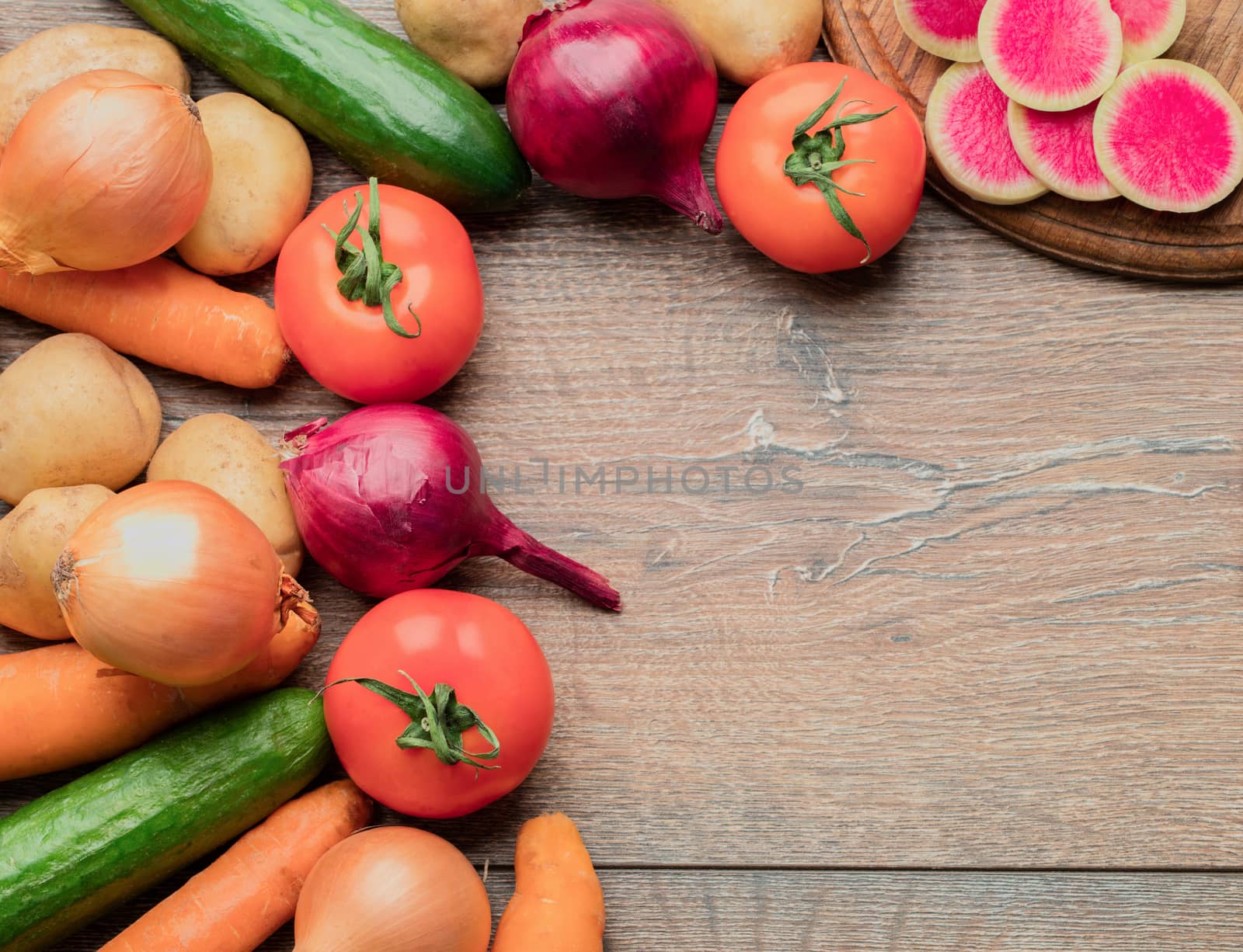 Set of fresh vegetables for the preparation of tasty and healthy food on a wooden table.