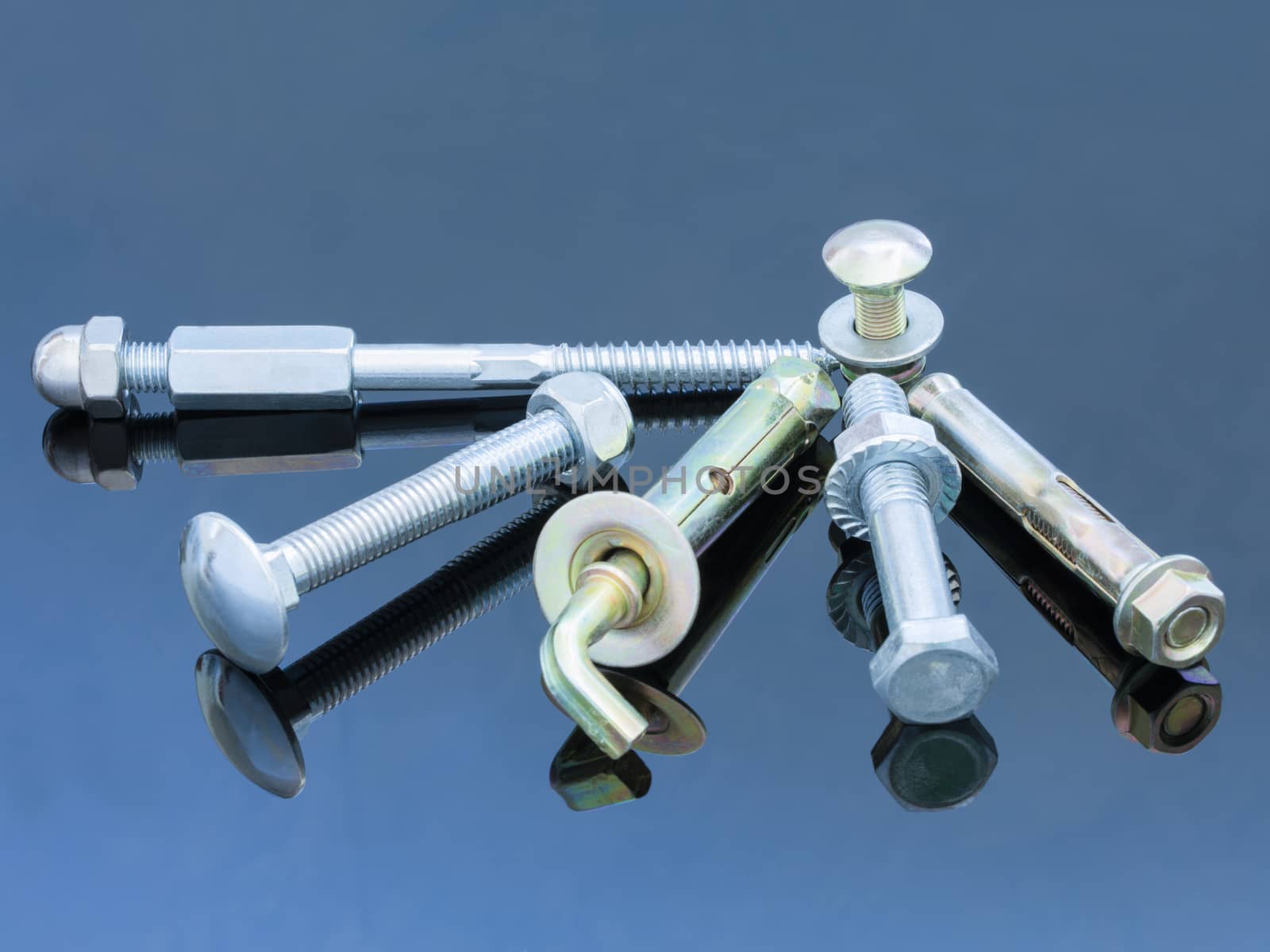 Screwbolts screw nuts, hanger and bolt washers on blue background construction concept. by Sergii