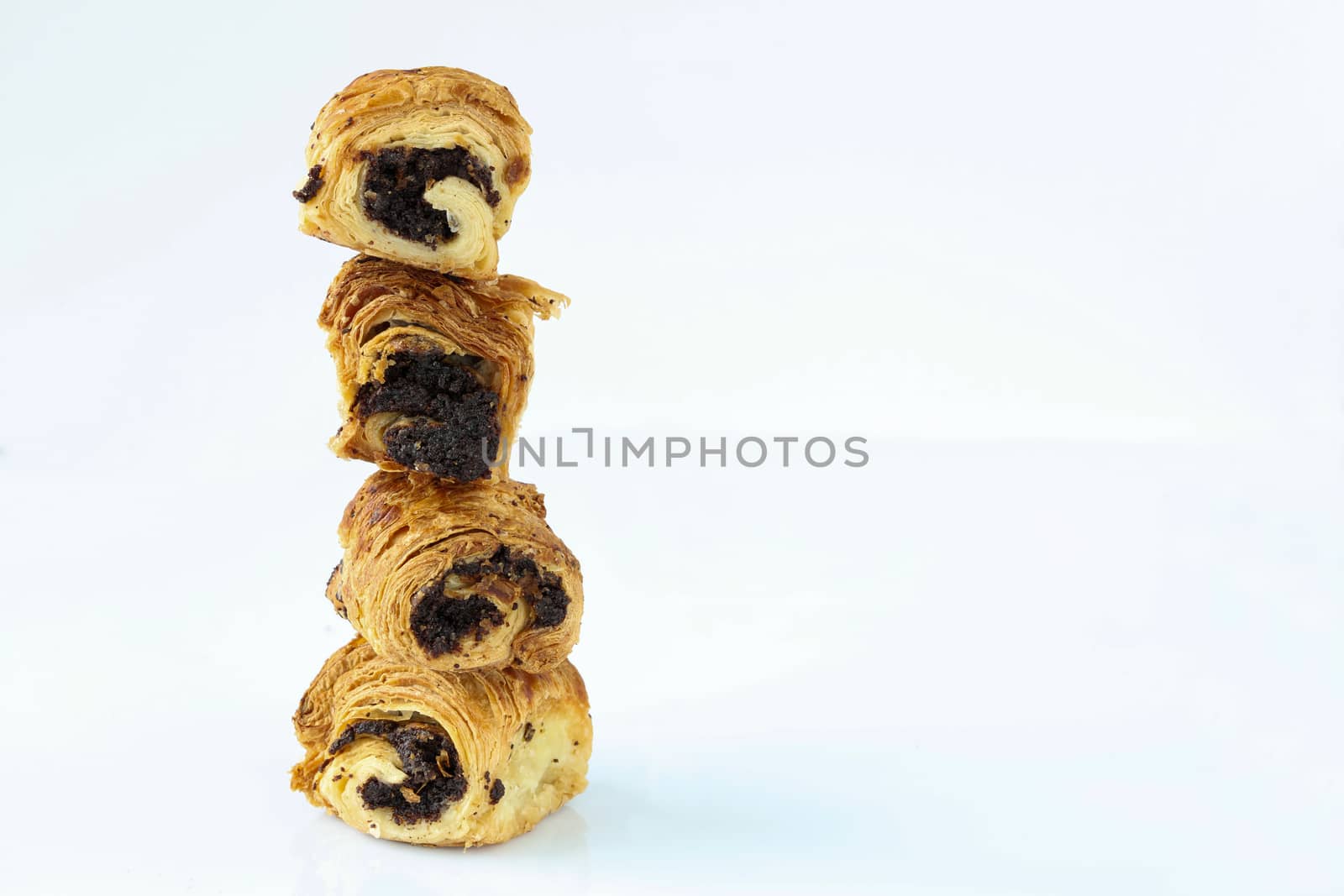 A tower of sweet rolls with poppies, which stand vertically on each other