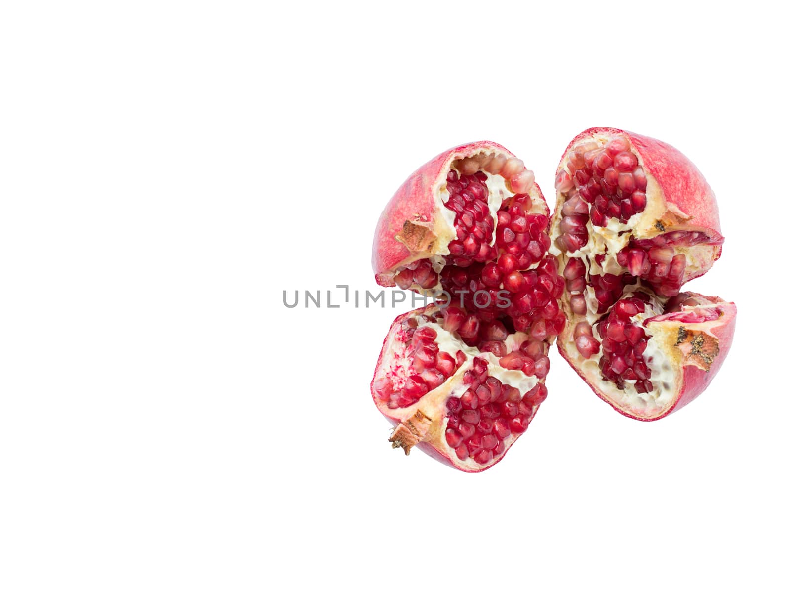 Ripe and red pomegranate fruits and divided into four parts, on a white isolated background