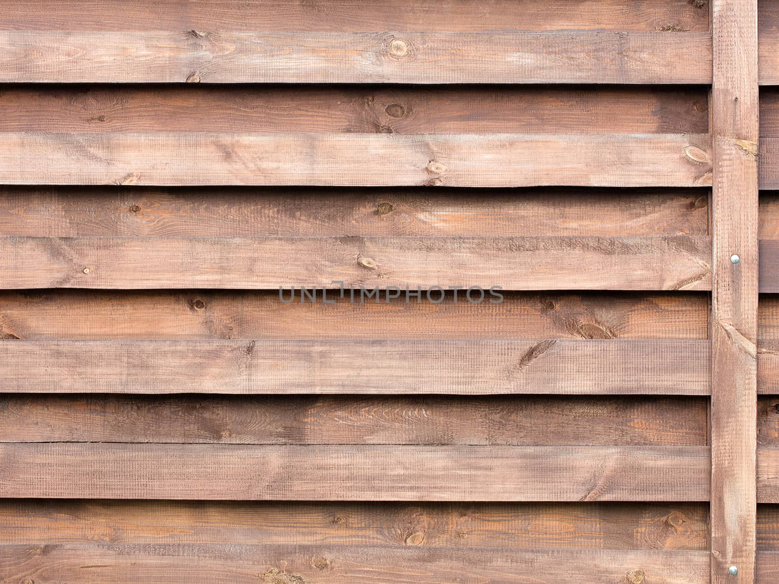 New horizontal wooden fence painted with protective composition