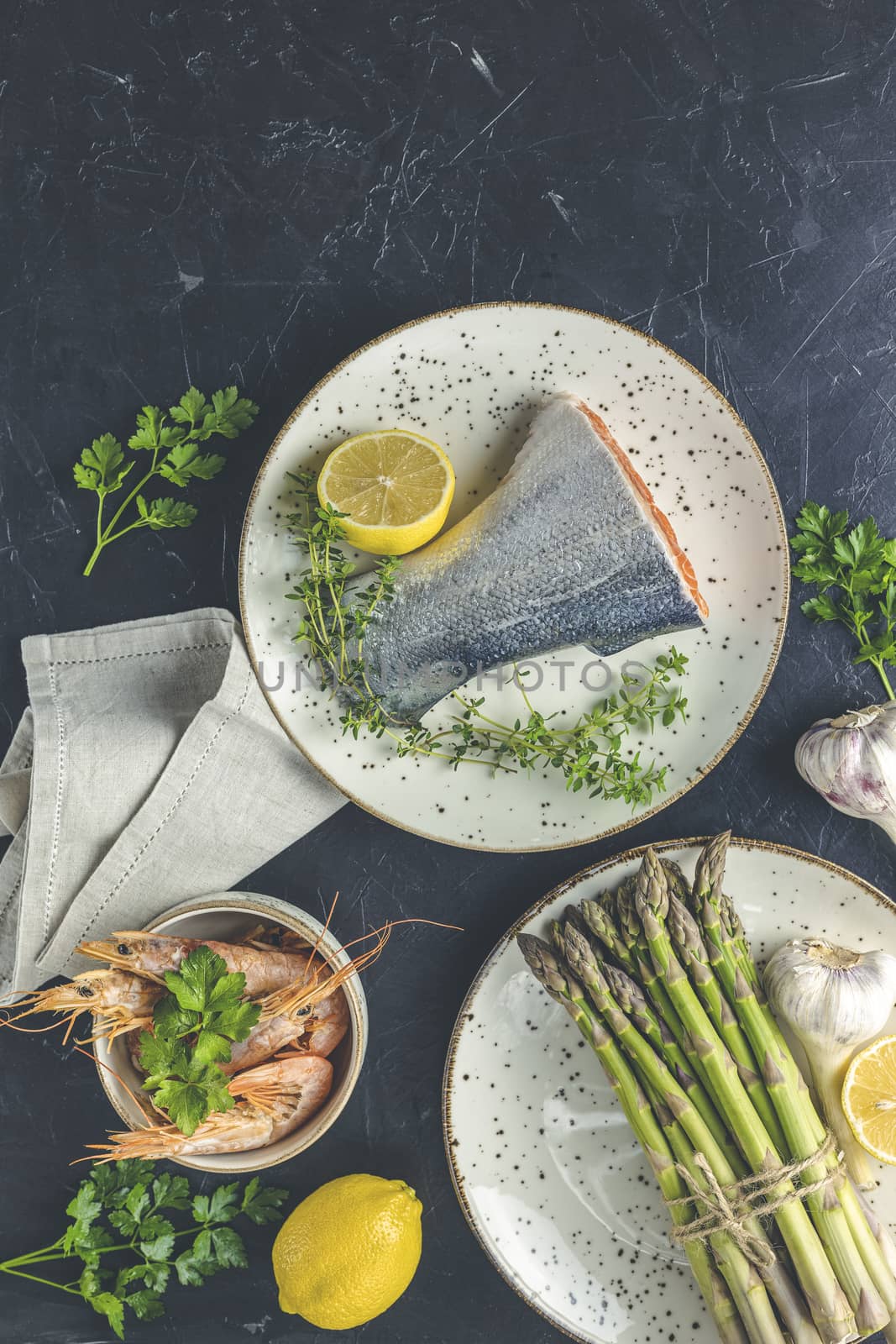 Trout fish  surrounded parsley, lemon, shrimp, prawn, asparagus  by ArtSvitlyna