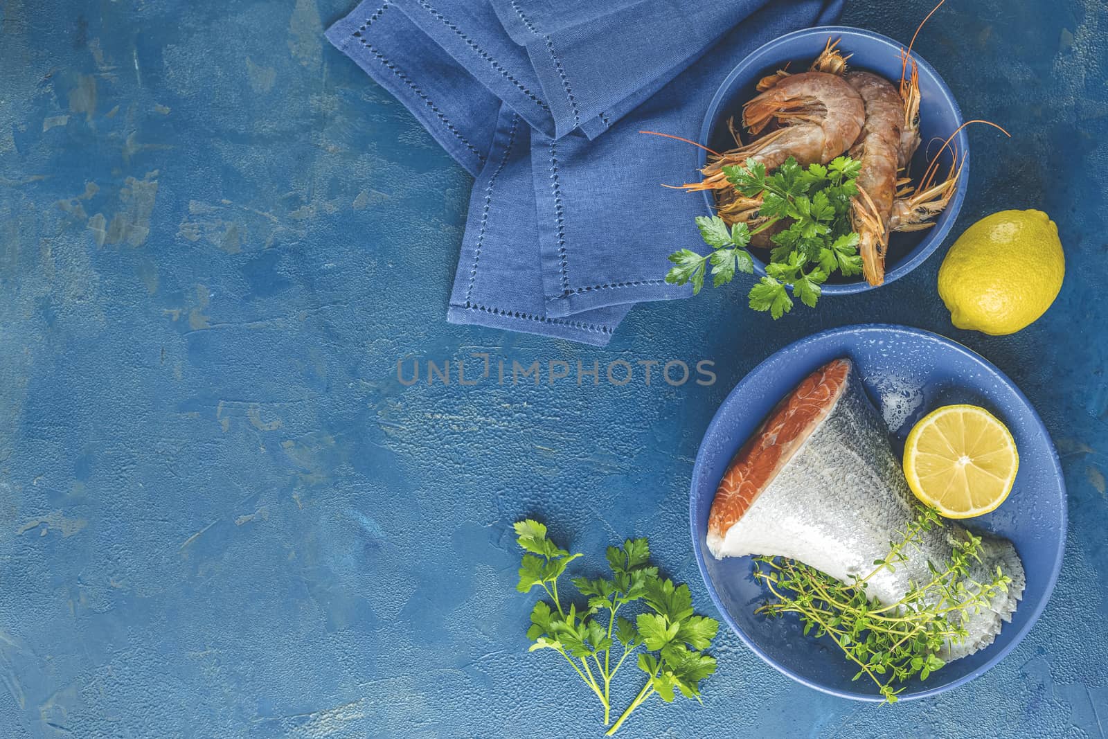 Trout fish surrounded parsley, lemon, shrimp, prawn in ceramic p by ArtSvitlyna