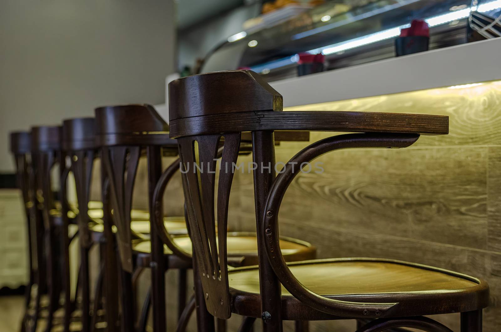Wooden stools for customers in a bar by efeGePh