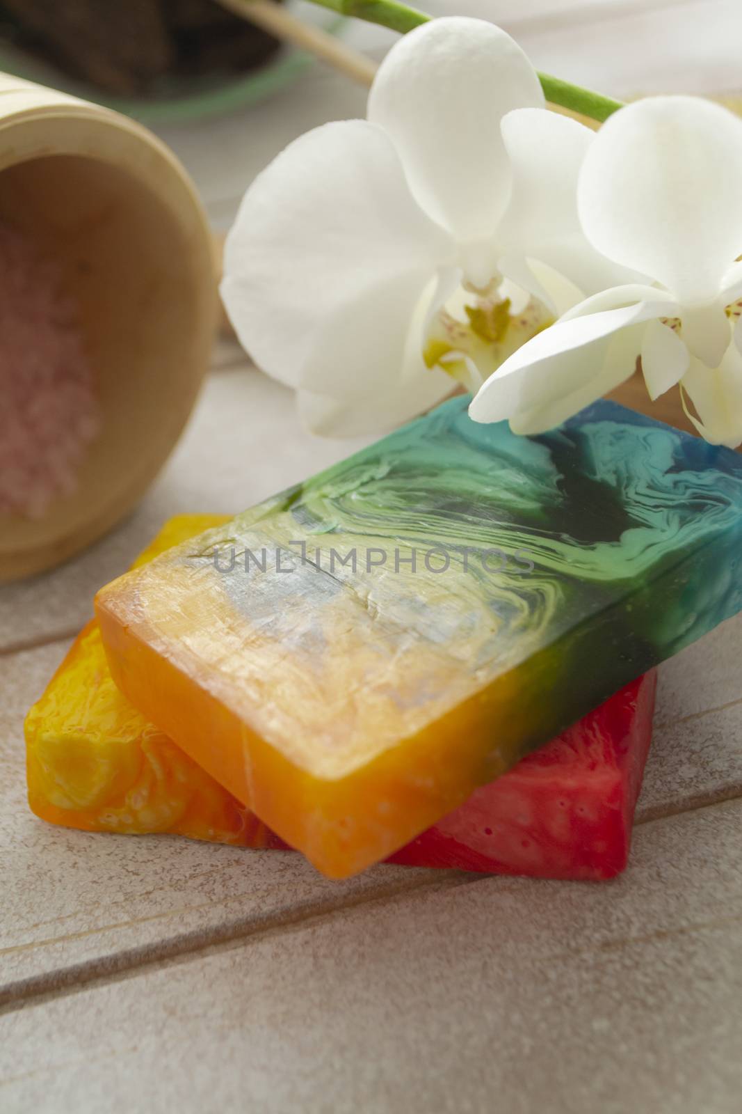 Bar of handmade natural soap and orchid flowers. Spa concept. Vertical