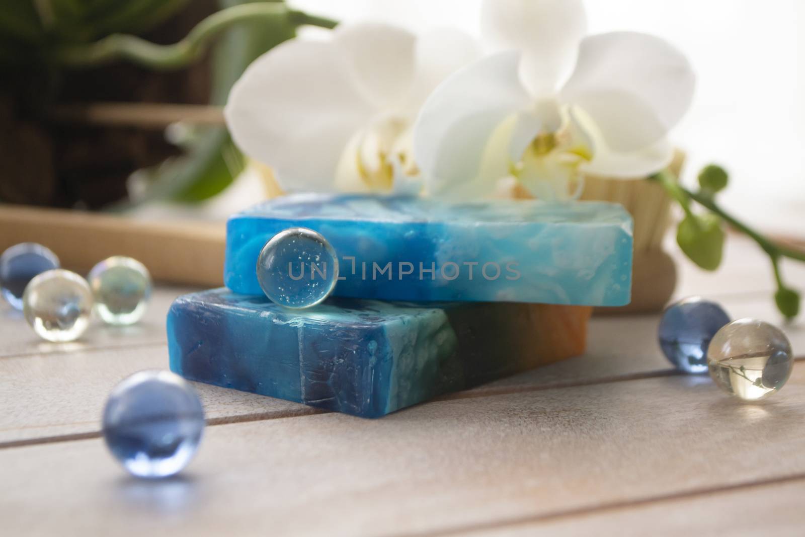 Sea salt, natural soap and orchid flower on wooden background. Aroma spa