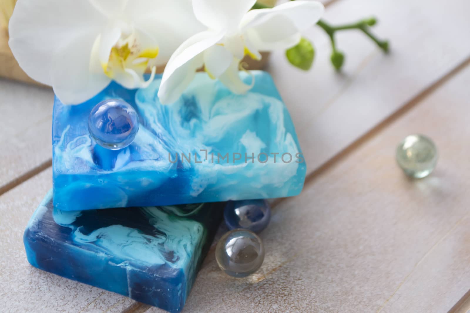Handmade sea soap in teal and blue, orchid flower