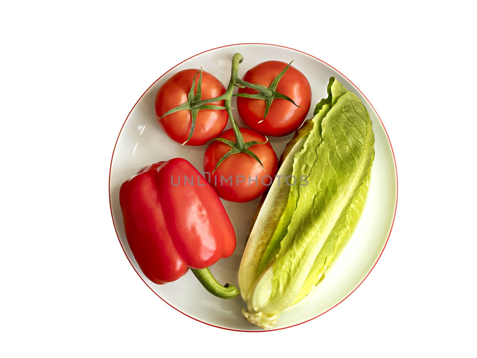 Whole fruits of fresh vegetables: Bulgarian pepper, tomato branch and romaine salad lie on white round porcelain plate with pomegranate rim close-up on white background