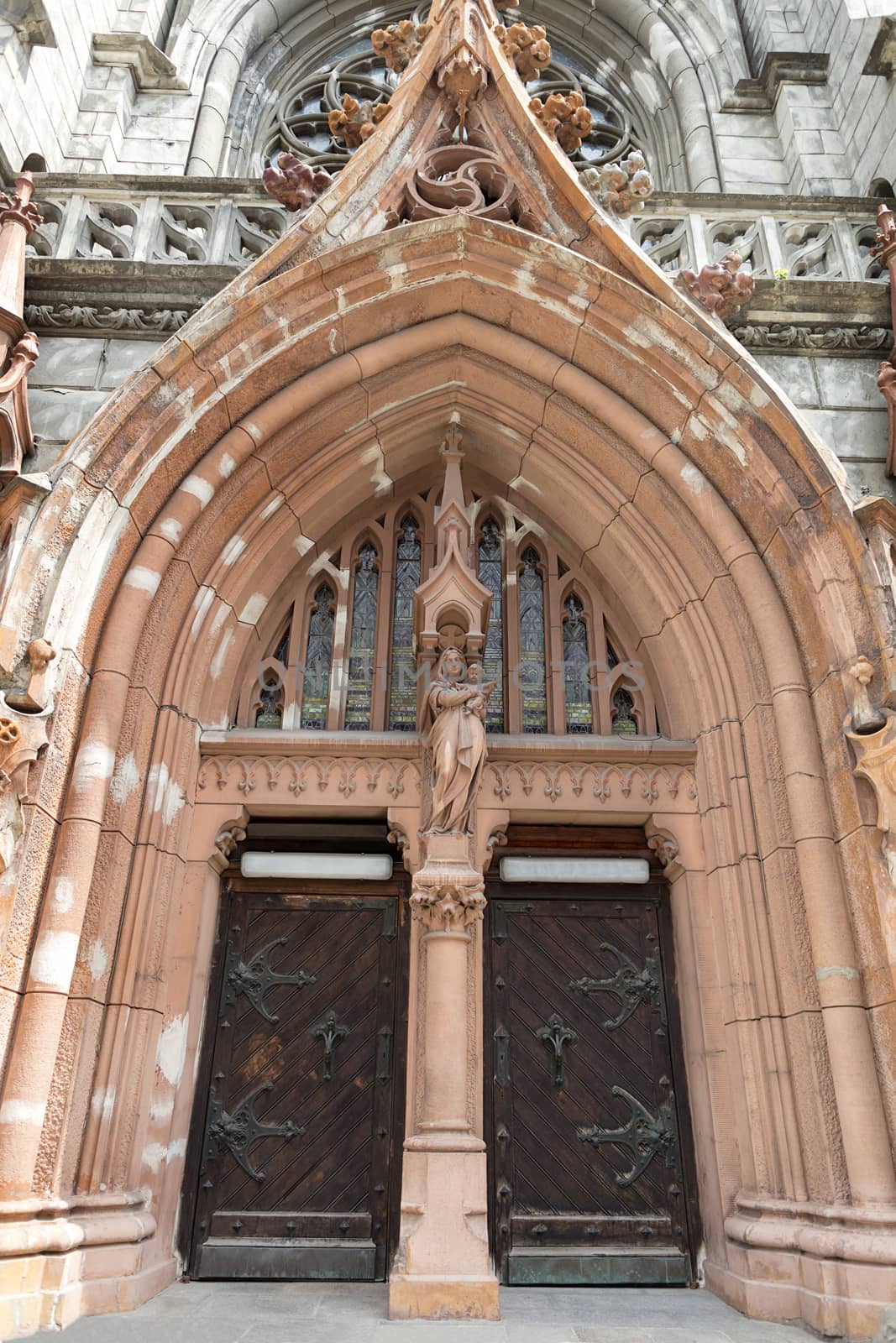 Chamber arch and entrance doors to the Roman Catholic Cathedral of St. Nicholas in Kiev, Virgin Mary with baby Jesus above Entrance Door.