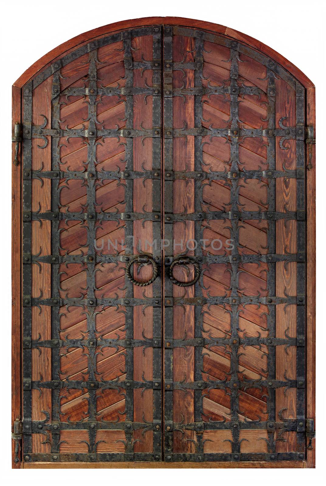 Antique wooden antique wooden doors with a forged iron grille and cross bars isolated on a white background.