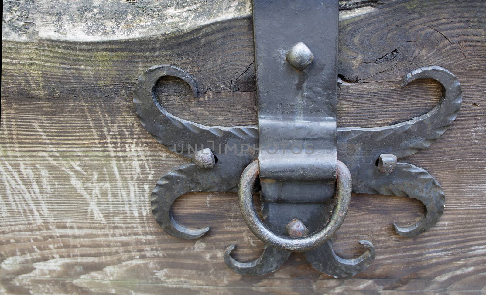 metal forged antique ring on the wall of the house, used for tying a horse