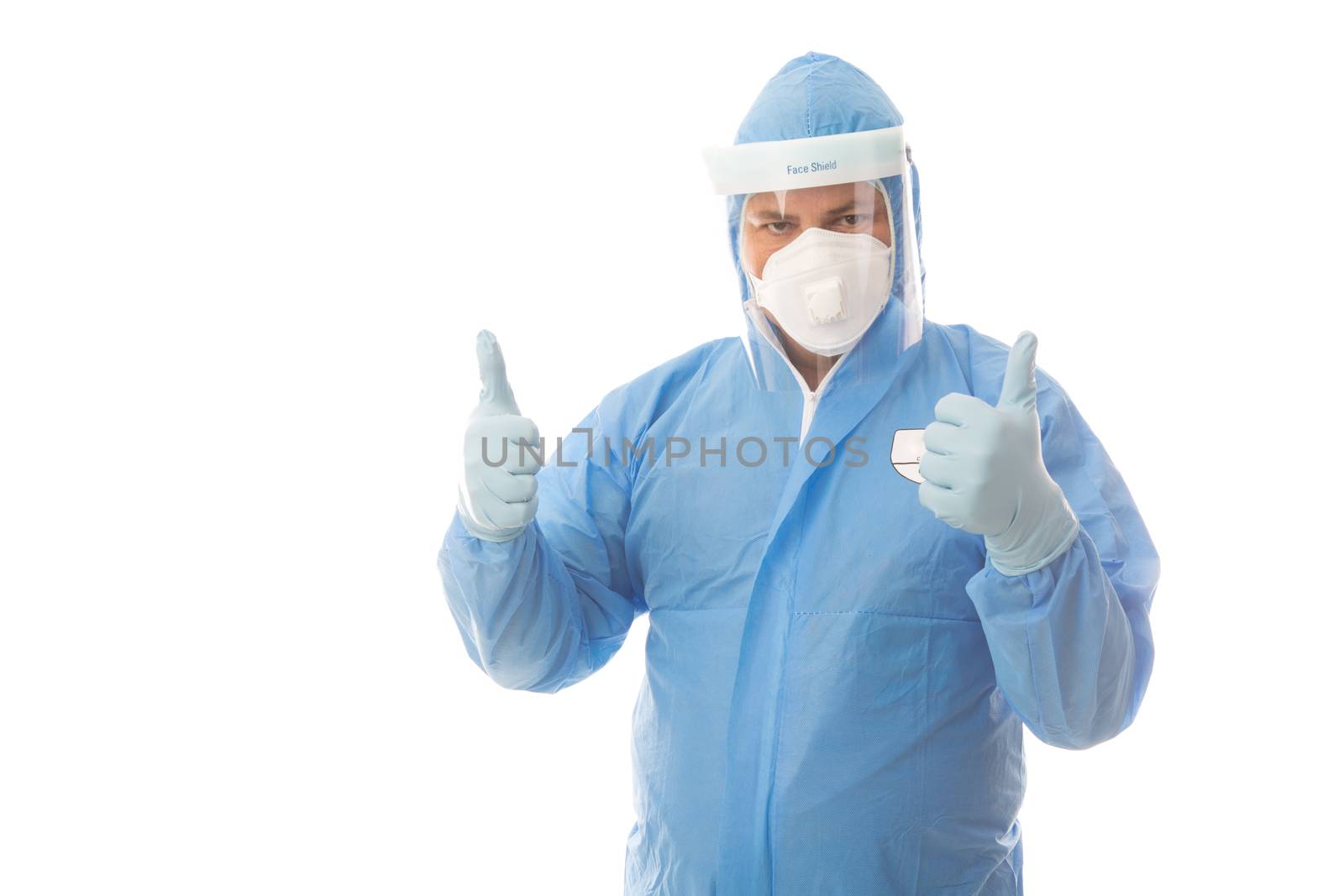 Healthcare or industrial worker in protective hazmat suit gives a successful thumbs up hand gesture.  Hazmat suits are used for industrial clean up, like asbestos and in clinical laboratory and medical industries for example treating coronavirus or ebola pandemics