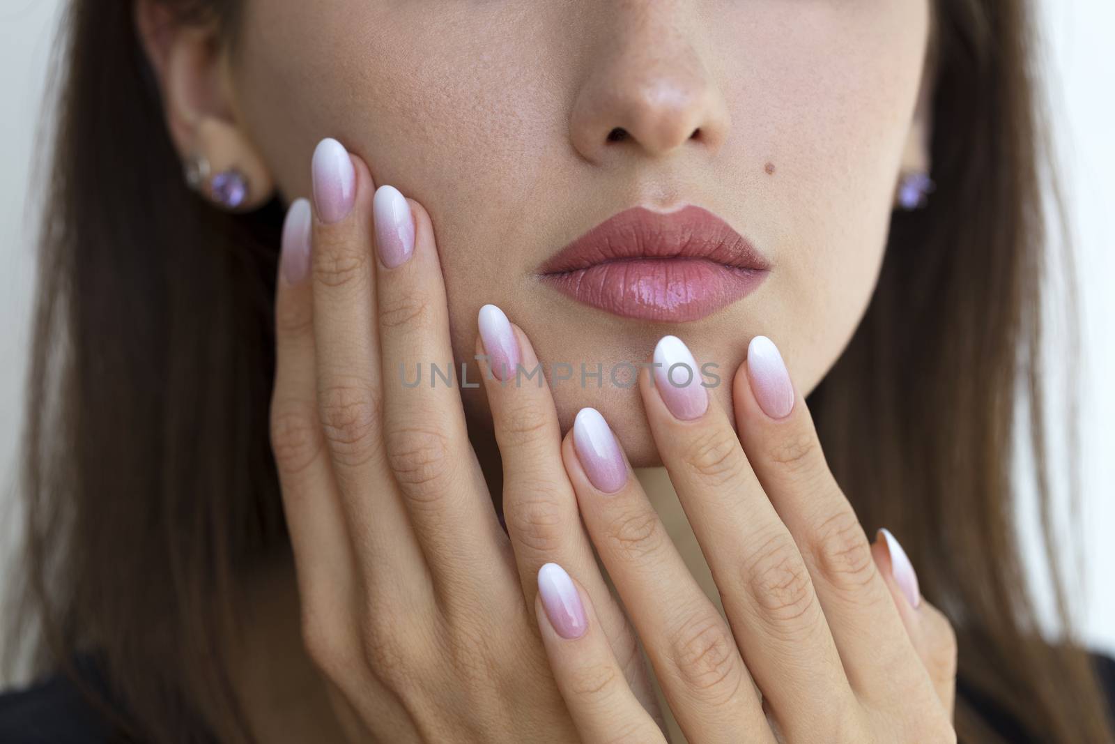 Beautiful woman's nails with beautiful french manicure ombre peach and white