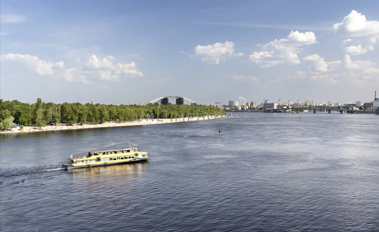 Pleasure boat goes along the Dnieper river on a bright sunny day by Sergii
