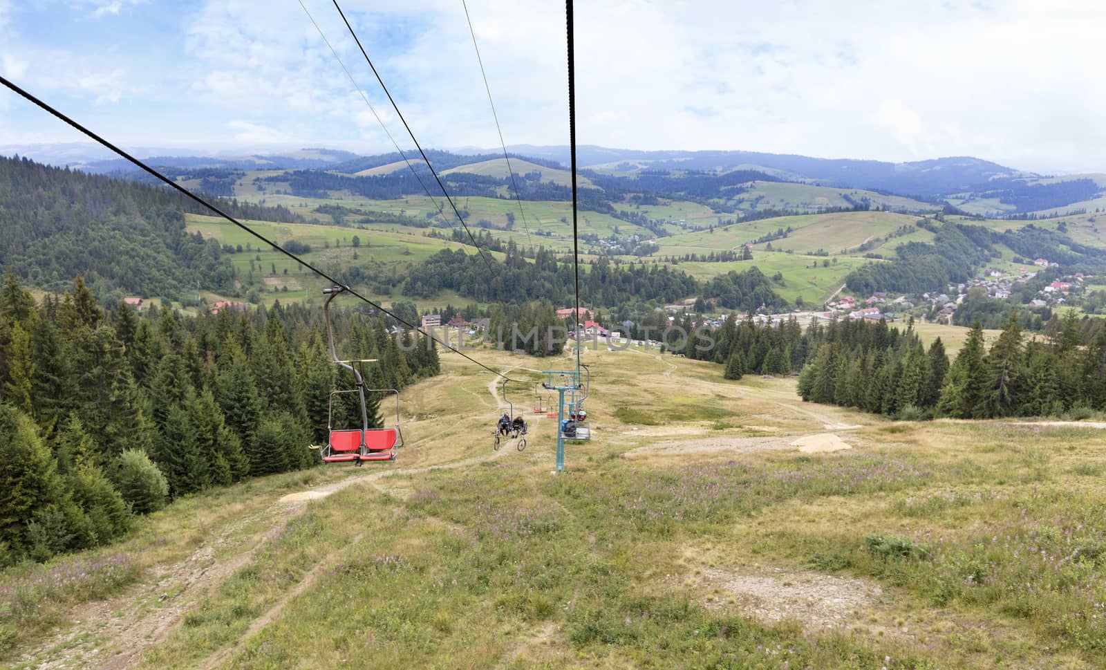 Beautiful mountain landscape of the Carpathian Mountains against the backdrop of a mountain lift carrying tourists