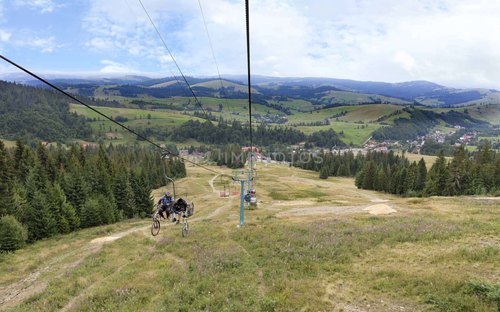 Beautiful mountain landscape of the Carpathian Mountains against the backdrop of a mountain lift carrying tourists