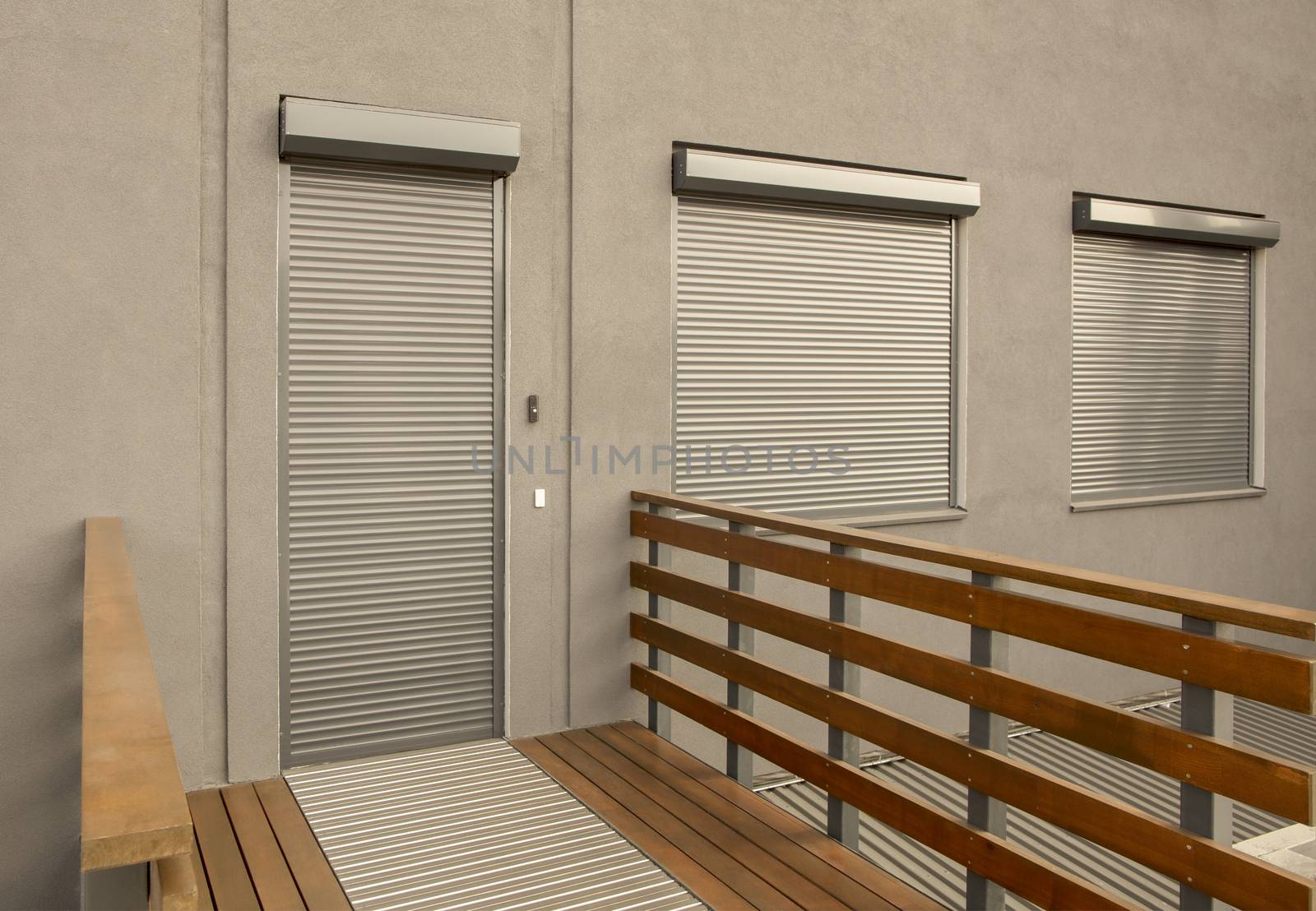 Light brown metal blinds on the doors and windows of the house