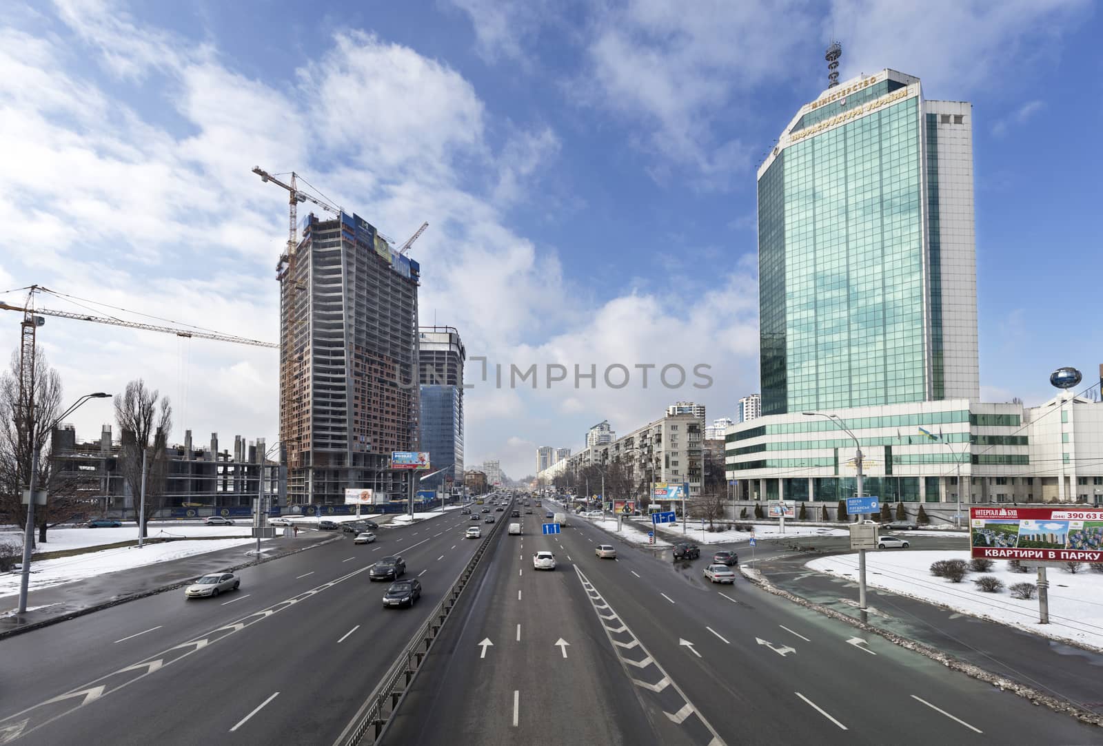 Kyiv, Ukraine. View over city traffic on Peremogi Prospect with Ministry of Infrastructure building in the background.