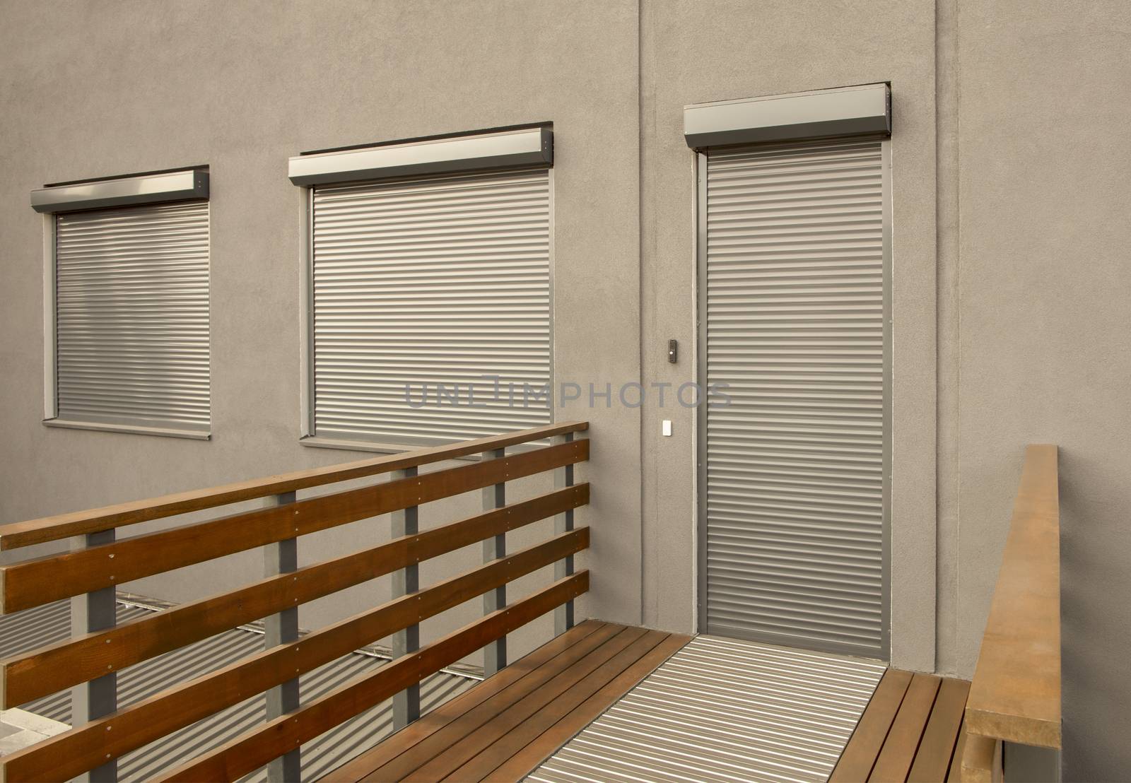 Metal blinds on the doors and windows of the facade of the house by Sergii