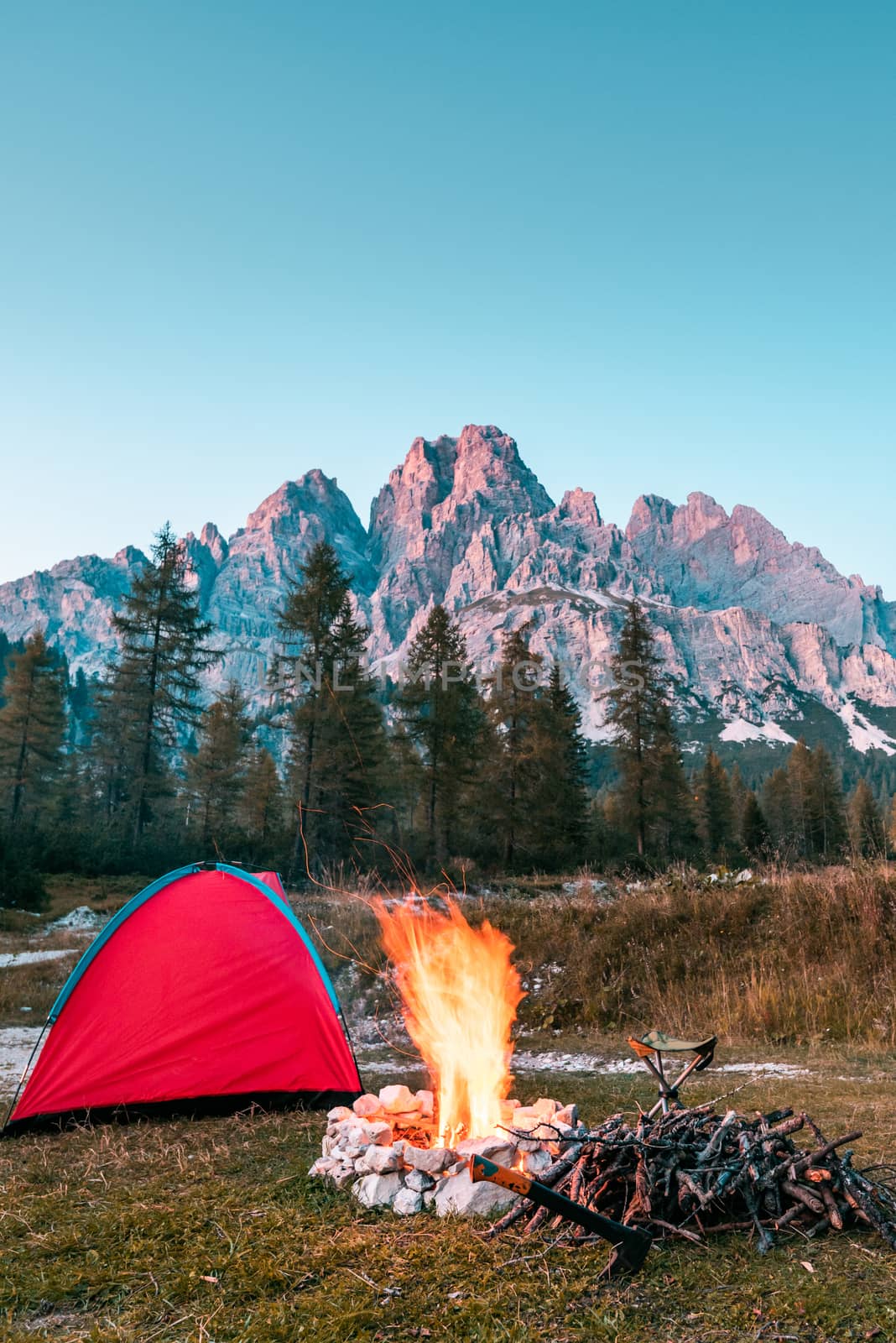 Campfire and Tent in Mountains. Leisure Activity Outdoors.