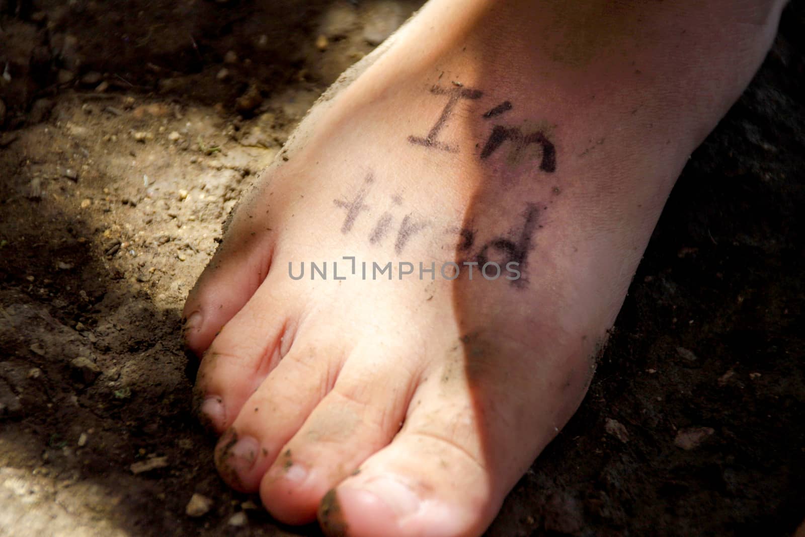 Photograph of a human feet and the phrase: Im tired