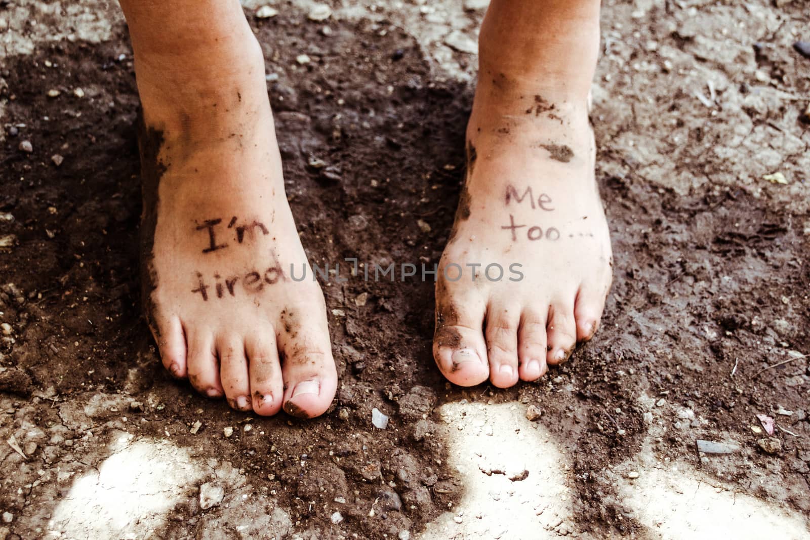 Photograph of a pair of human feet and the phrase: Im tired, me too
