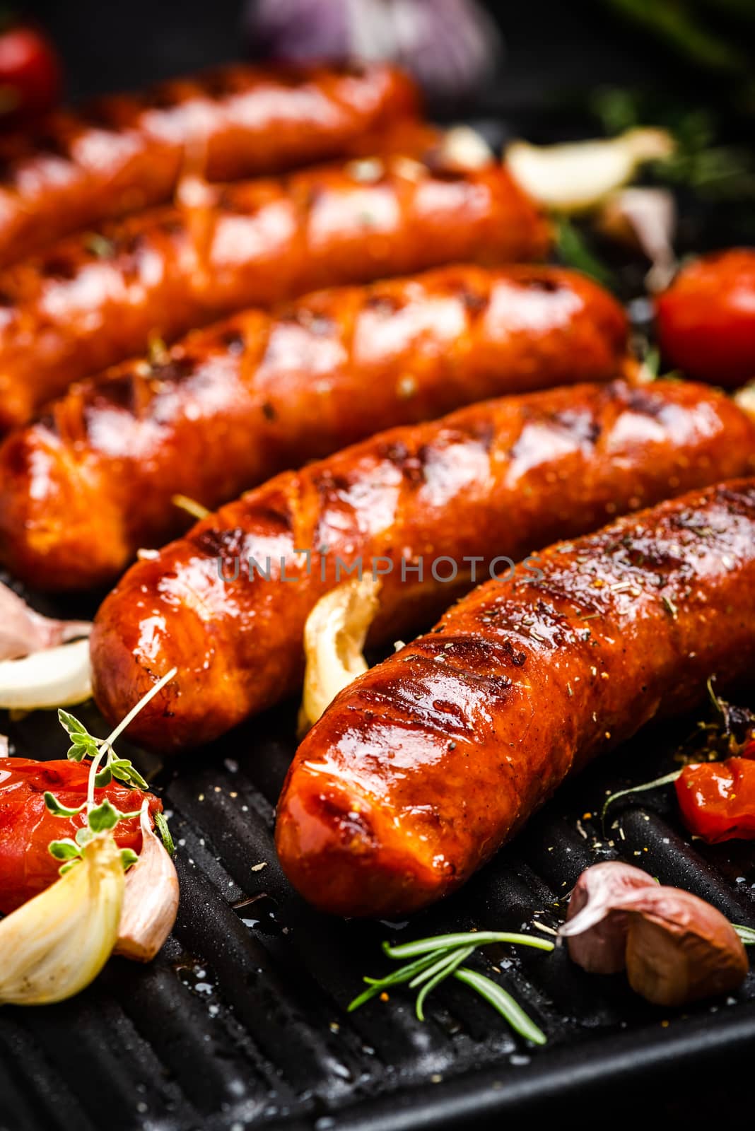 Grilled Sausages with Fresh Herbs and Spices. Close Up View on Grill. Summer Party Food.