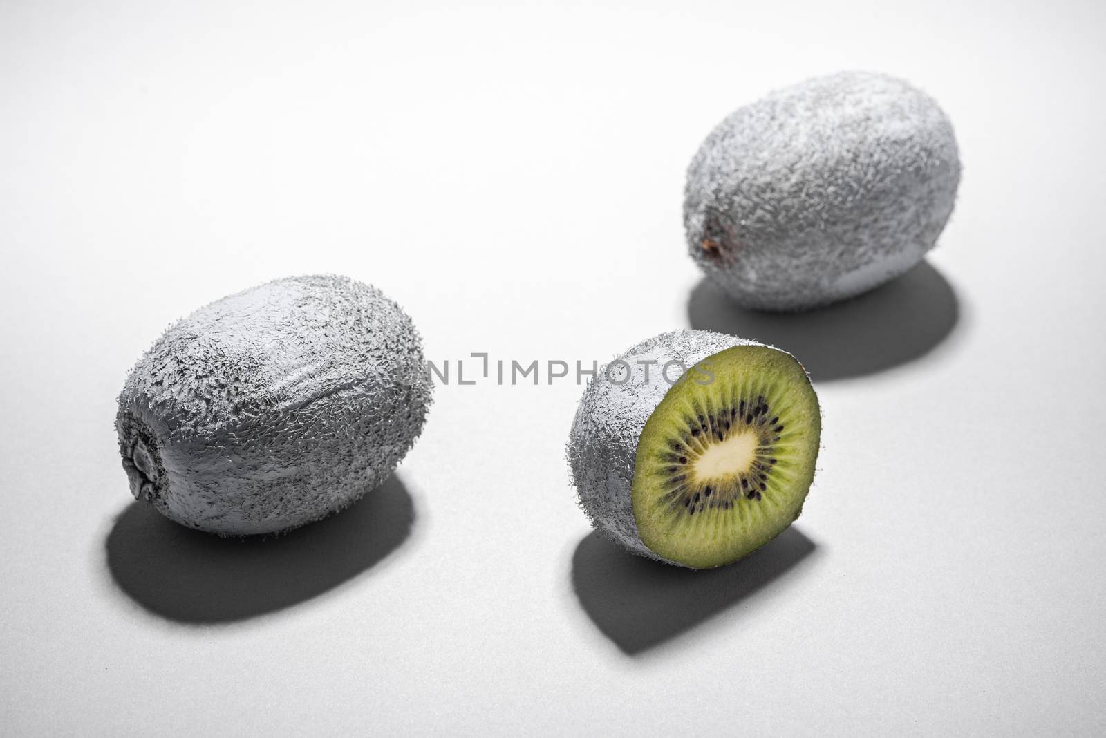 Modern Food Design. Monochrome Painted Kiwi Fruit Whole and Cut. Abstract Food Background.
