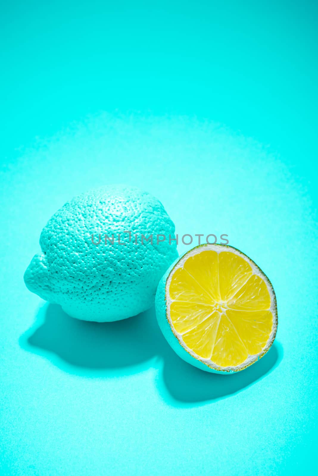 Blue Abstract Lemon Fruit Whole and Cut Half on Pastel Blue Background.
