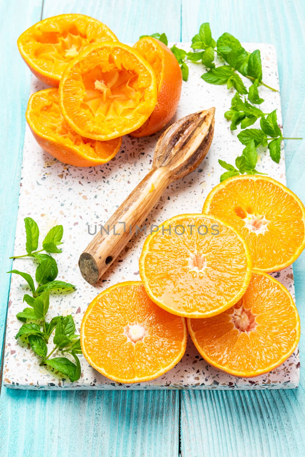 Orange Slices and Wooden Squeezer. Homemade Orange Juice Reicipe.