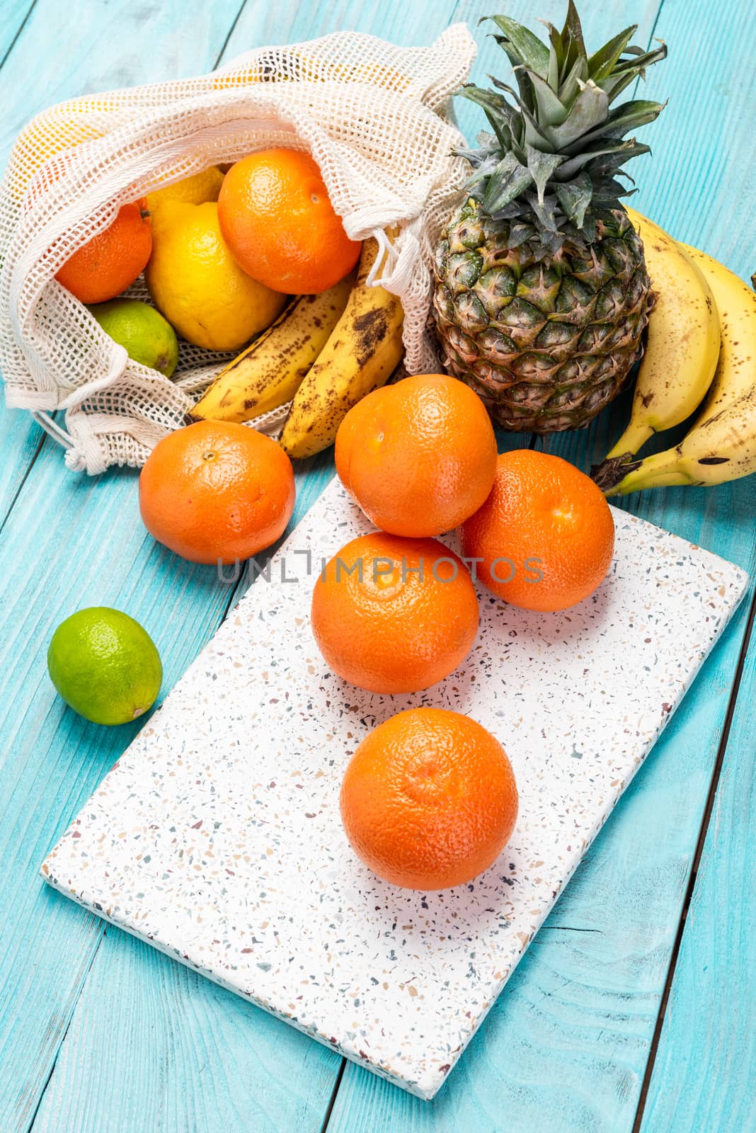 Fresh Orange and Tropical Fruits on Wooden Table. Vibrant Colors Healthy Eating.