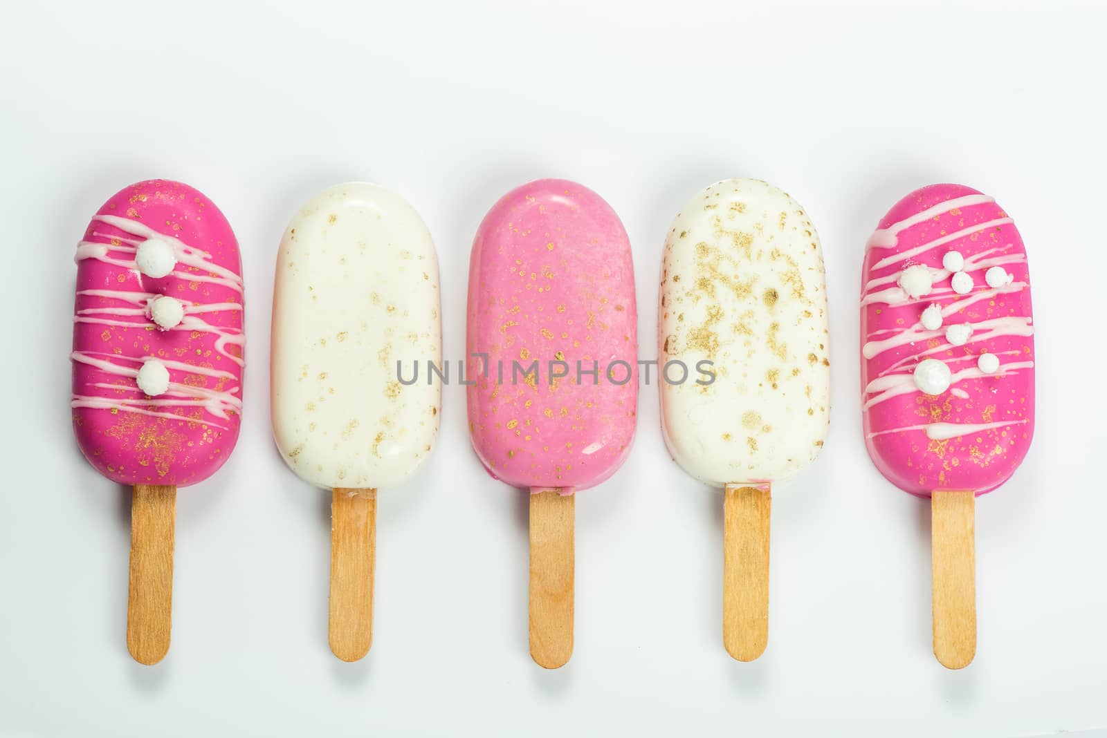 Selection of Pink Pastel and White Chocolate Popsicles. Wedding Sweet Food.