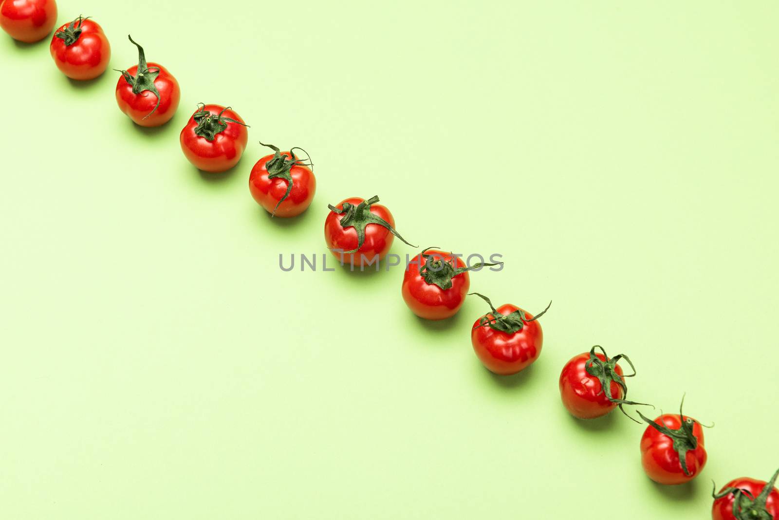 Vibrant Red Tomatoes on Green Background, Flat Lay Vegetable Pattern. Top View.