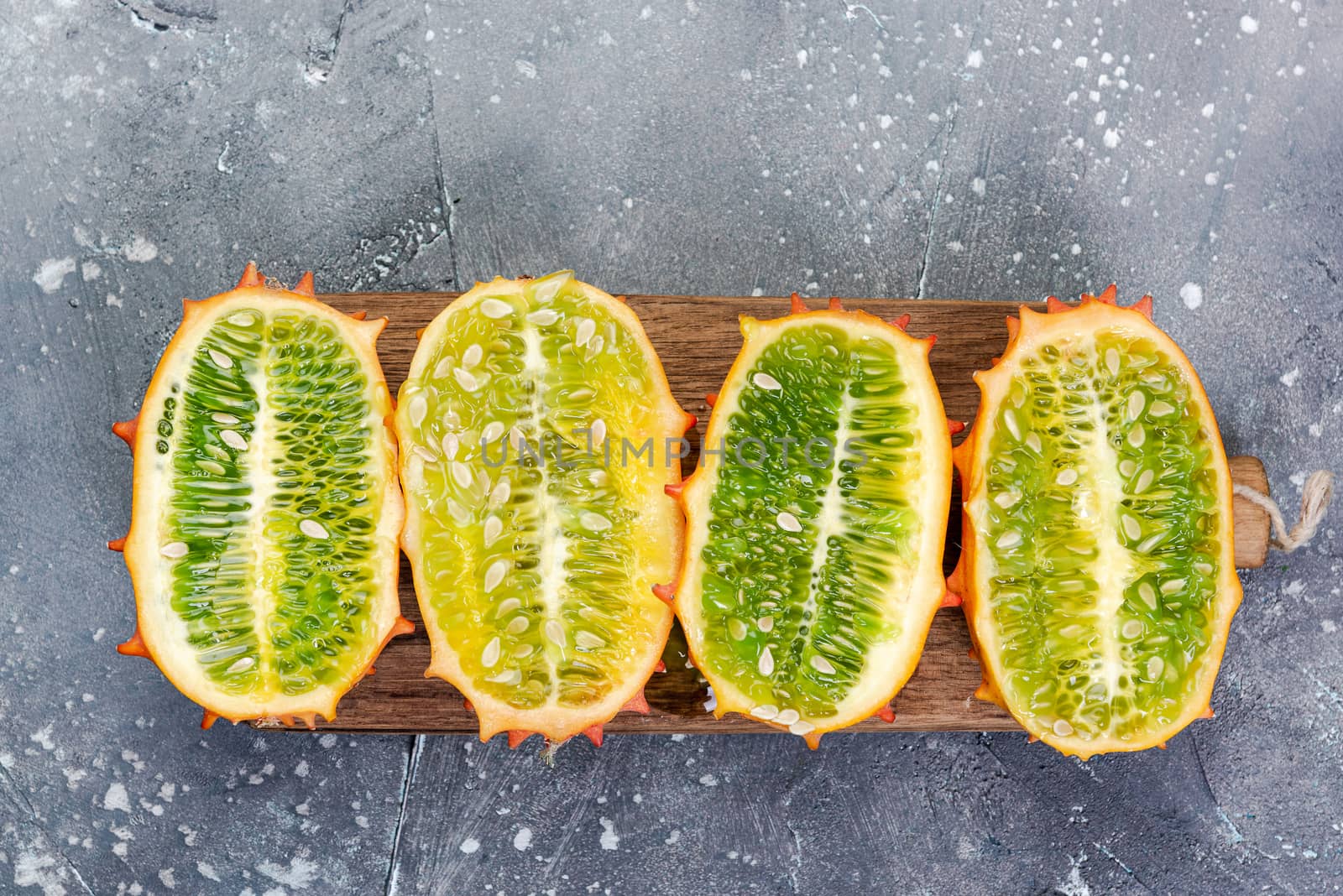 Kiwano or Horned Melon Exotic Fruits Cut in Half on Board. Copy  by merc67