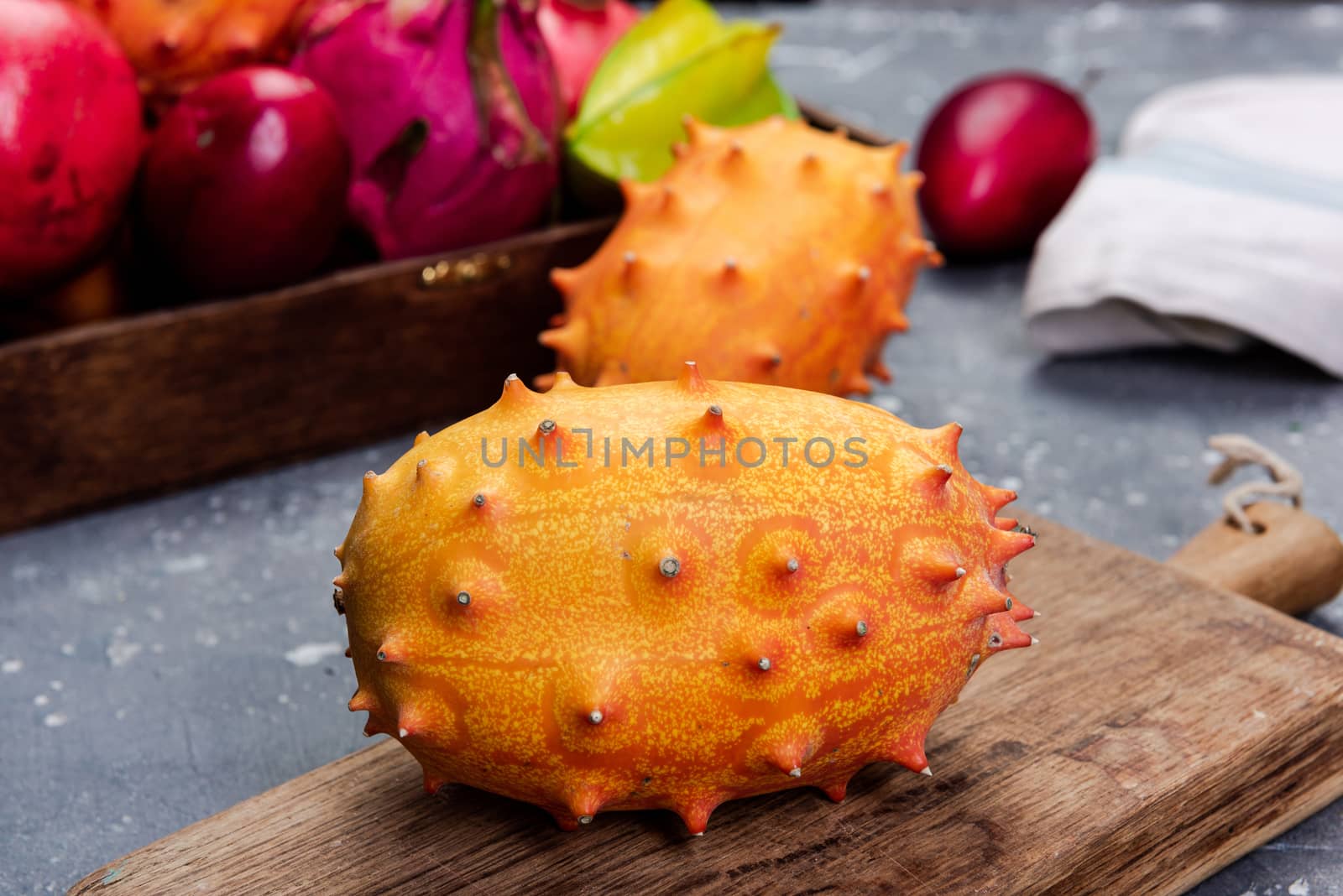 Whole Kiwano or Horned Melon Exotic Fruit on Cutting Board by merc67