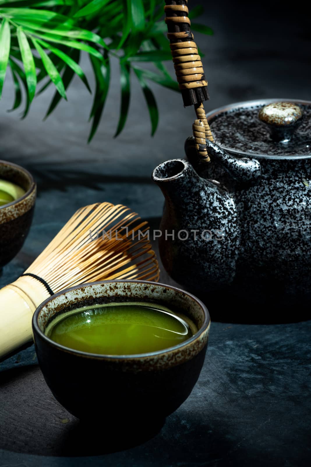 Matcha Green Tea in Bowl with Bamboo Whisk.