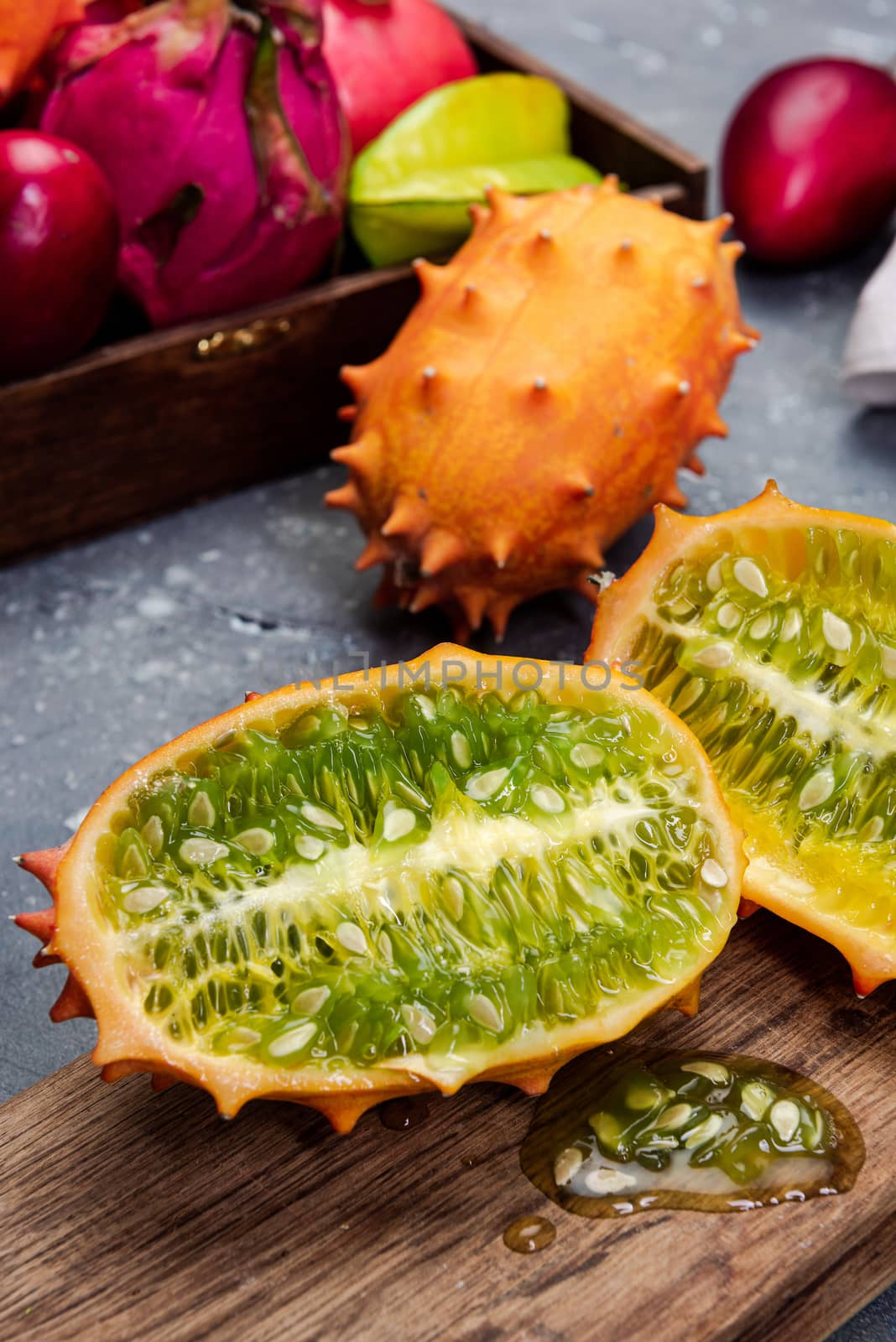 Whole and Cut Kiwano or Horned Melon Exotic Fruit on Board by merc67