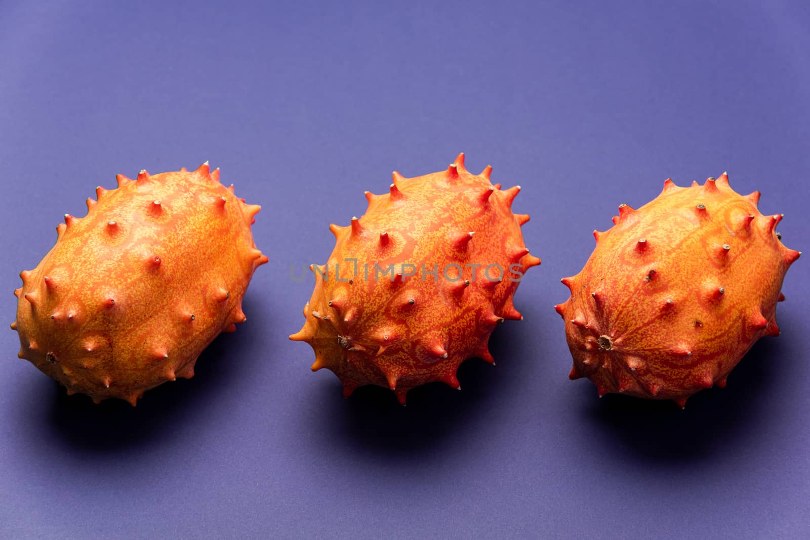 Kiwano Fruits or Horned Melon on Purple Pastel Background.