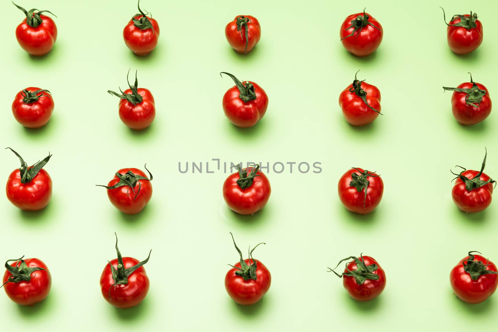 Vibrant Red Tomatoes on Green Background, Flat Lay Vegetable Pattern. Top View.
