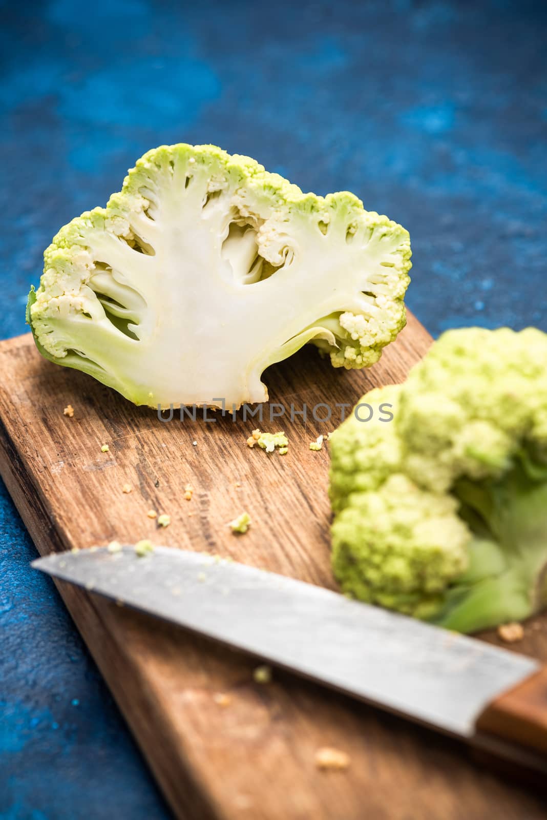 Green Cauliflower Cabbage on Cutting Board. Market Fresh Organic Food. Plant Based Diet.