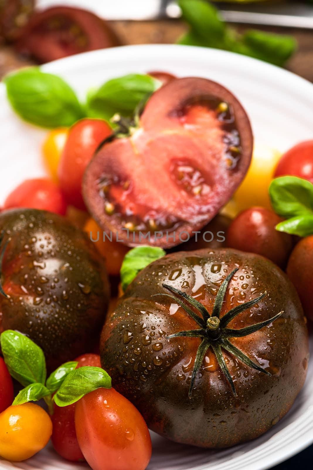 Vibrant Fresh Tomatoes. Vegan Food Market Fresh. Colorful Tomatoes on Conrete Background.