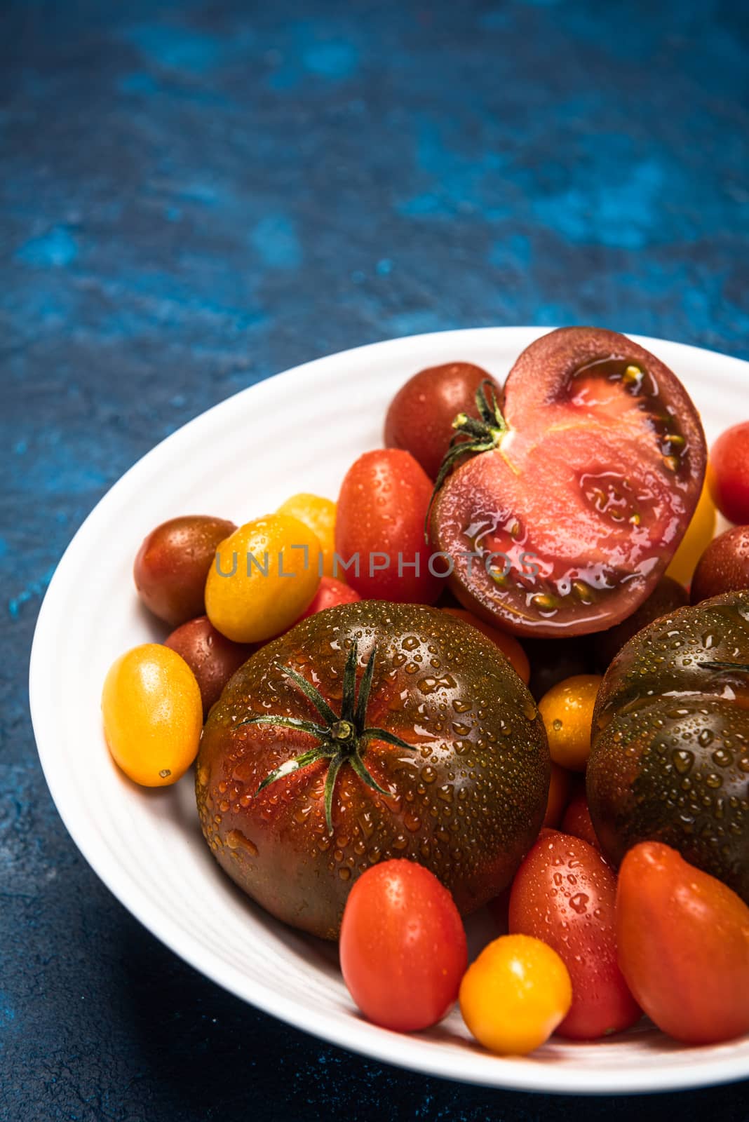 Vibrant Organic Tomatoes on Plate. Market Fresh Vegan Food. Plan by merc67