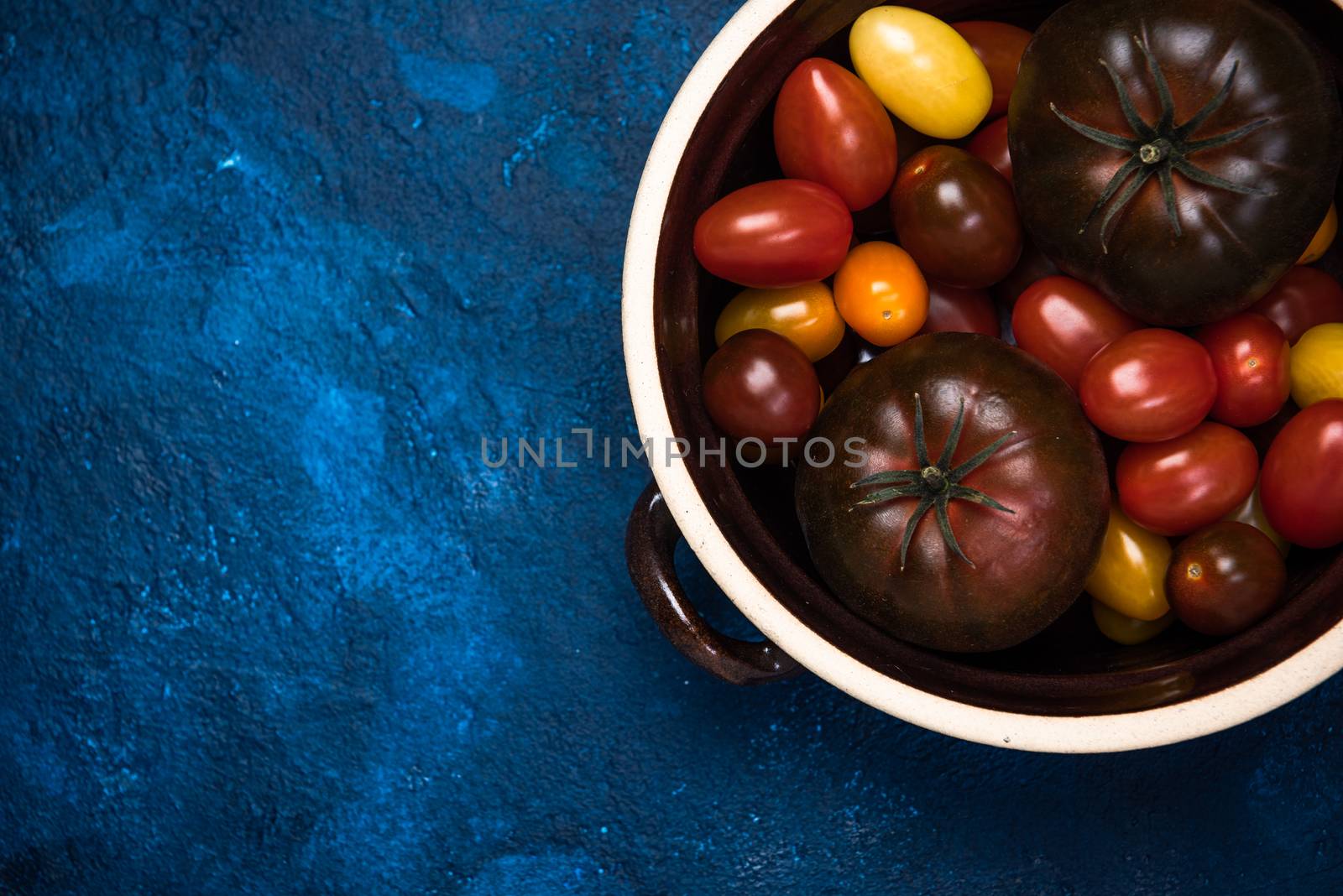 Market Fresh Organic Tomatoes on Concrete Kitchen Table Top by merc67