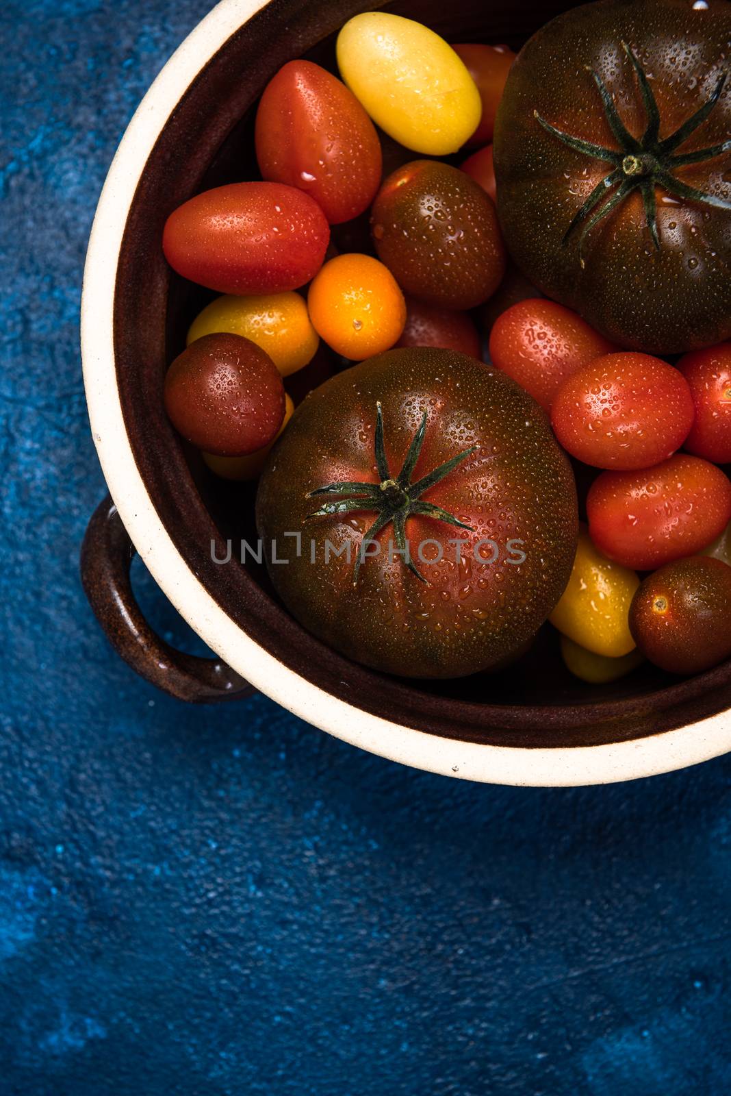 Organic Fresh Tomatoes in Ceramic Pan. Food Background by merc67