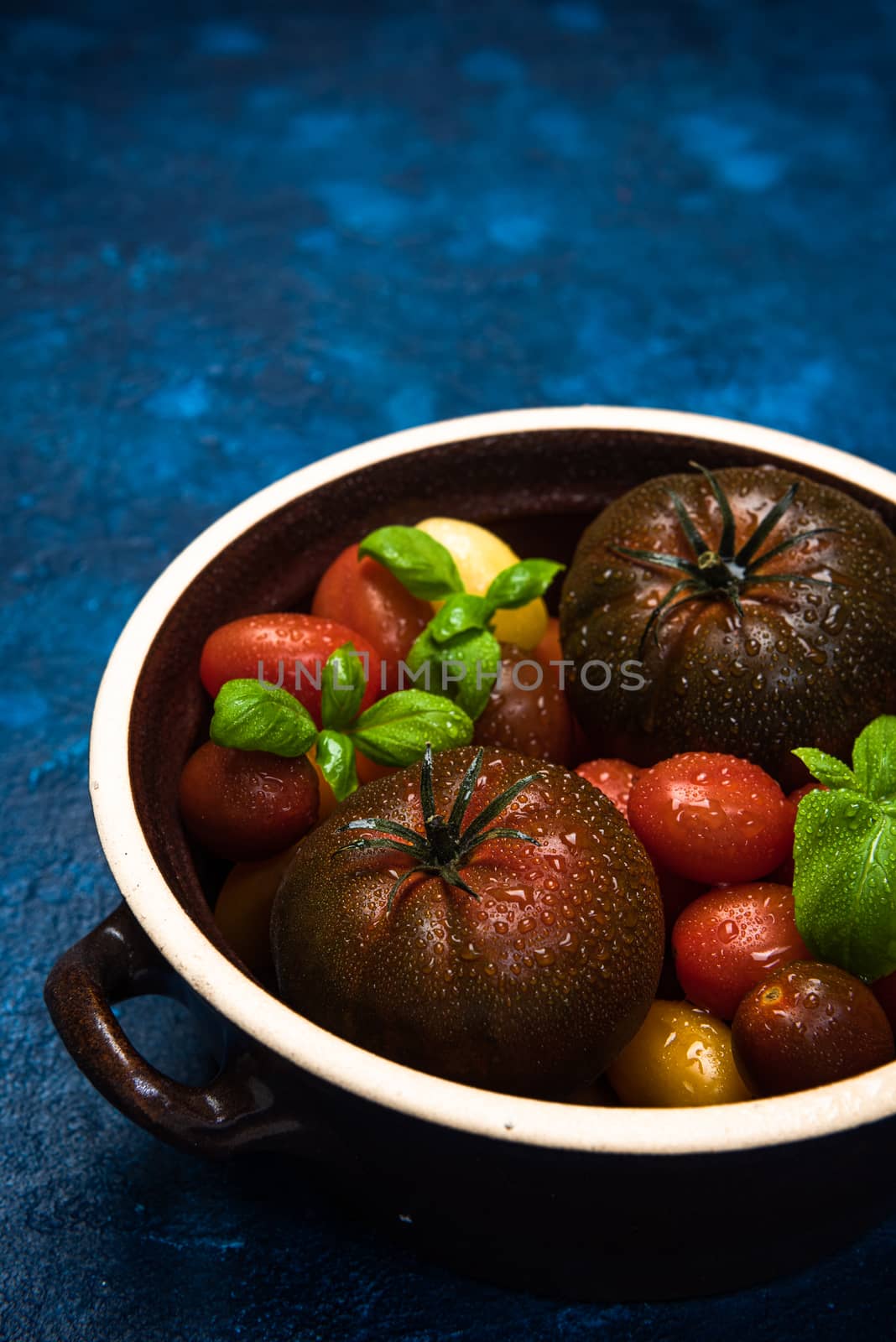 Market Fresh Organic Tomatoes on Concrete Kitchen Table Top.