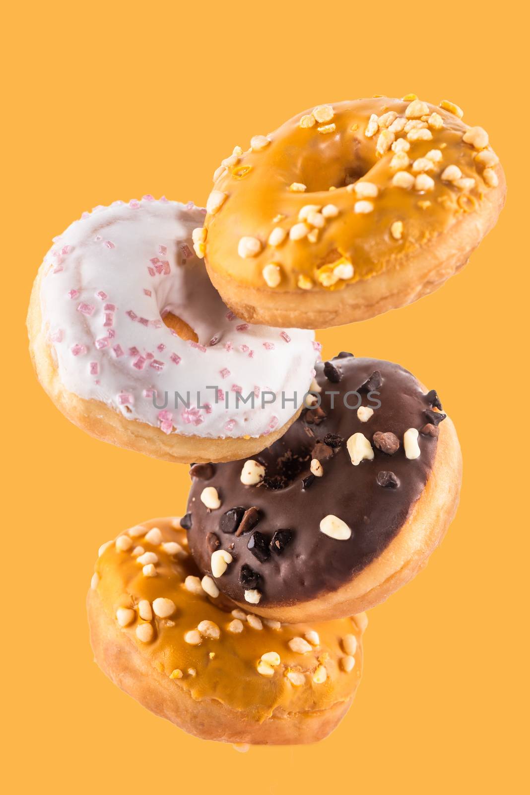 Flying Donut or Doughnut Creative Image. Falling Food On White Background. Food in Motion.