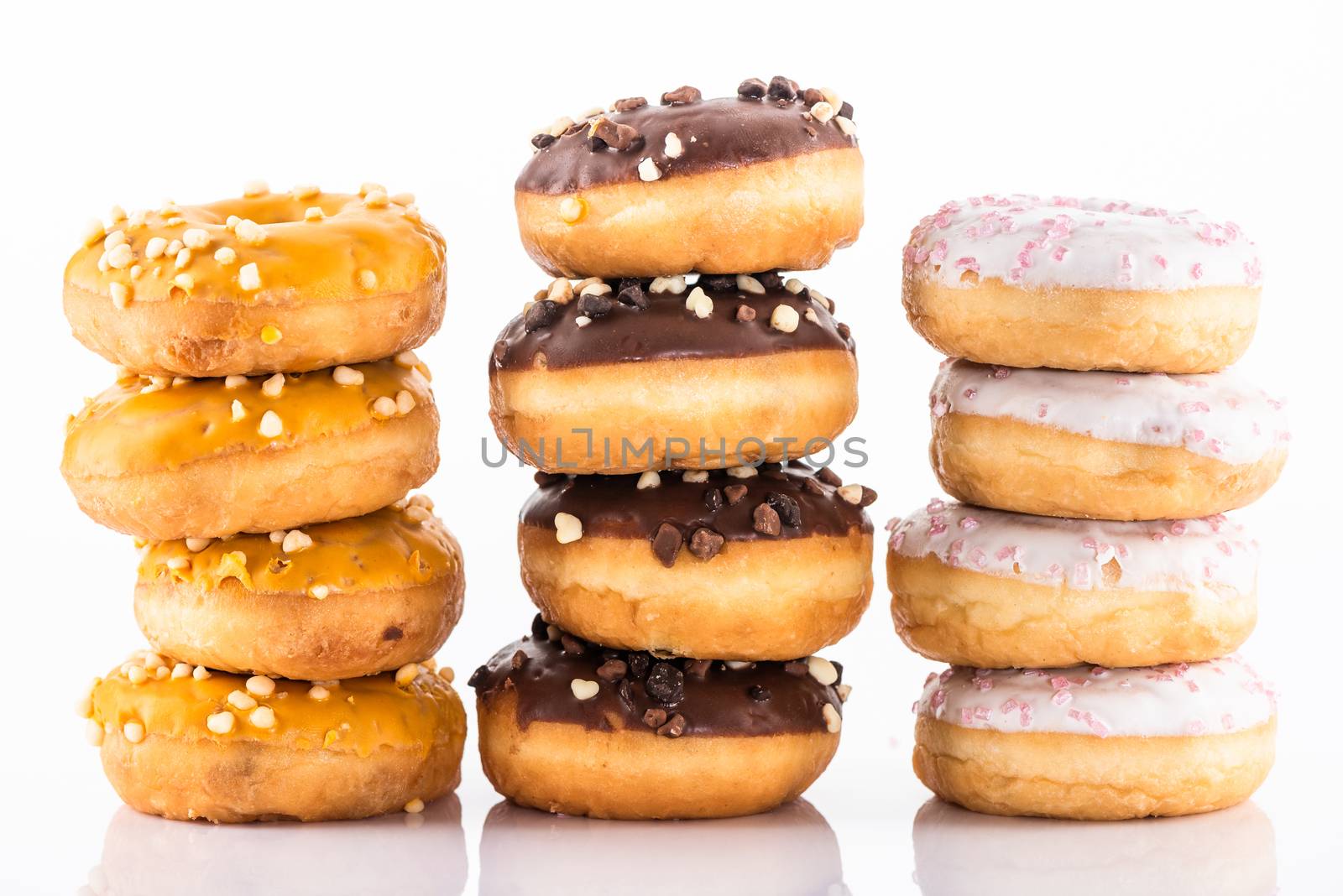 Donuts or Doughnuts Tower on White Background. Donut Stack Pile Food Background.